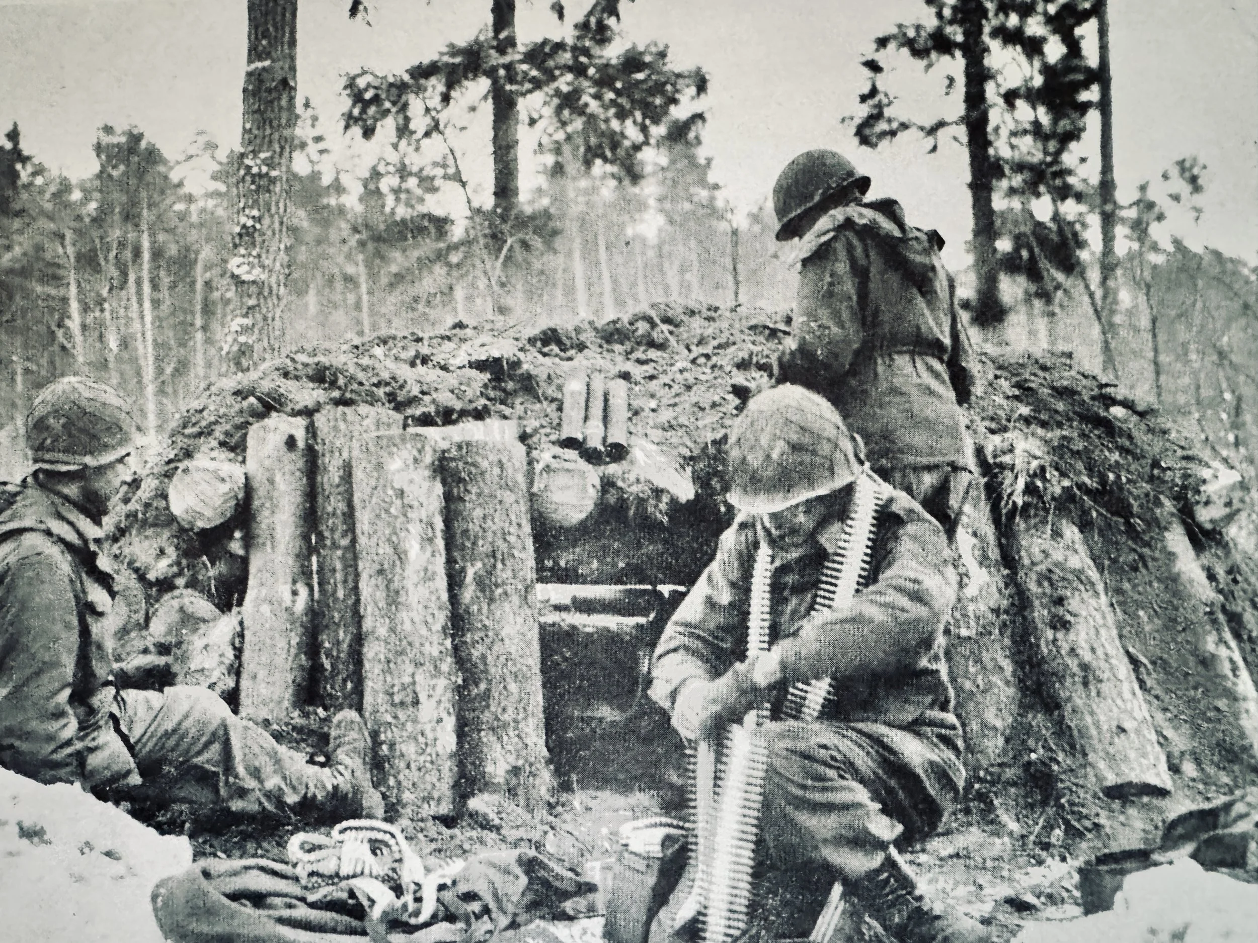 Soldiers of the 42nd Rainbow Infantry Division's Task Force Linden prepare a defensive position at a log and dirt bunker machine gun emplacement, France, January 1945, during Operation Nordwind.