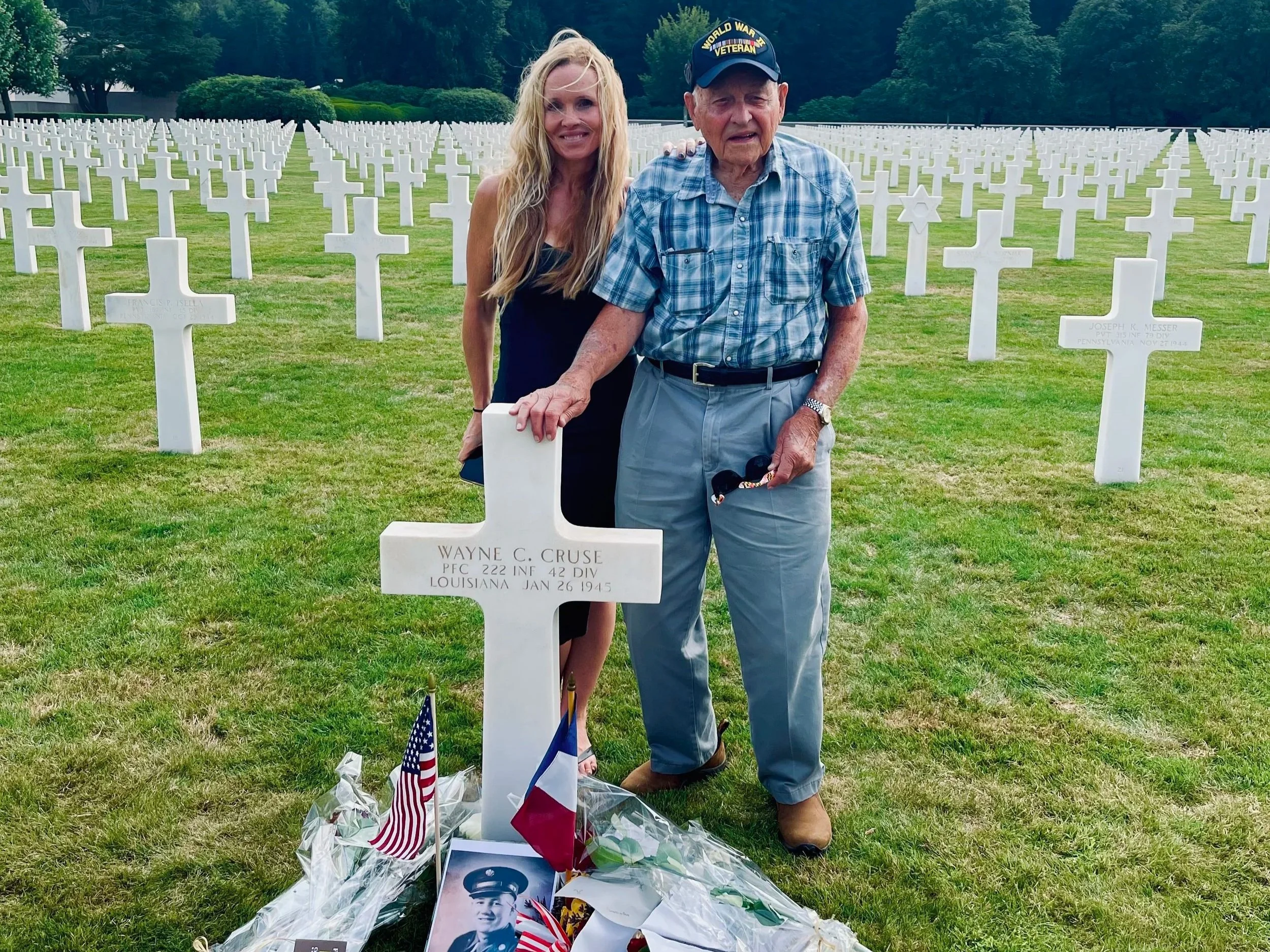Historian Erin Faith Allen and 42nd Rainbow Division veteran Lockered Bud Gahs at the grave of PFC Wayne C. Cruse, Épinal American Cemetery, France, August 2022