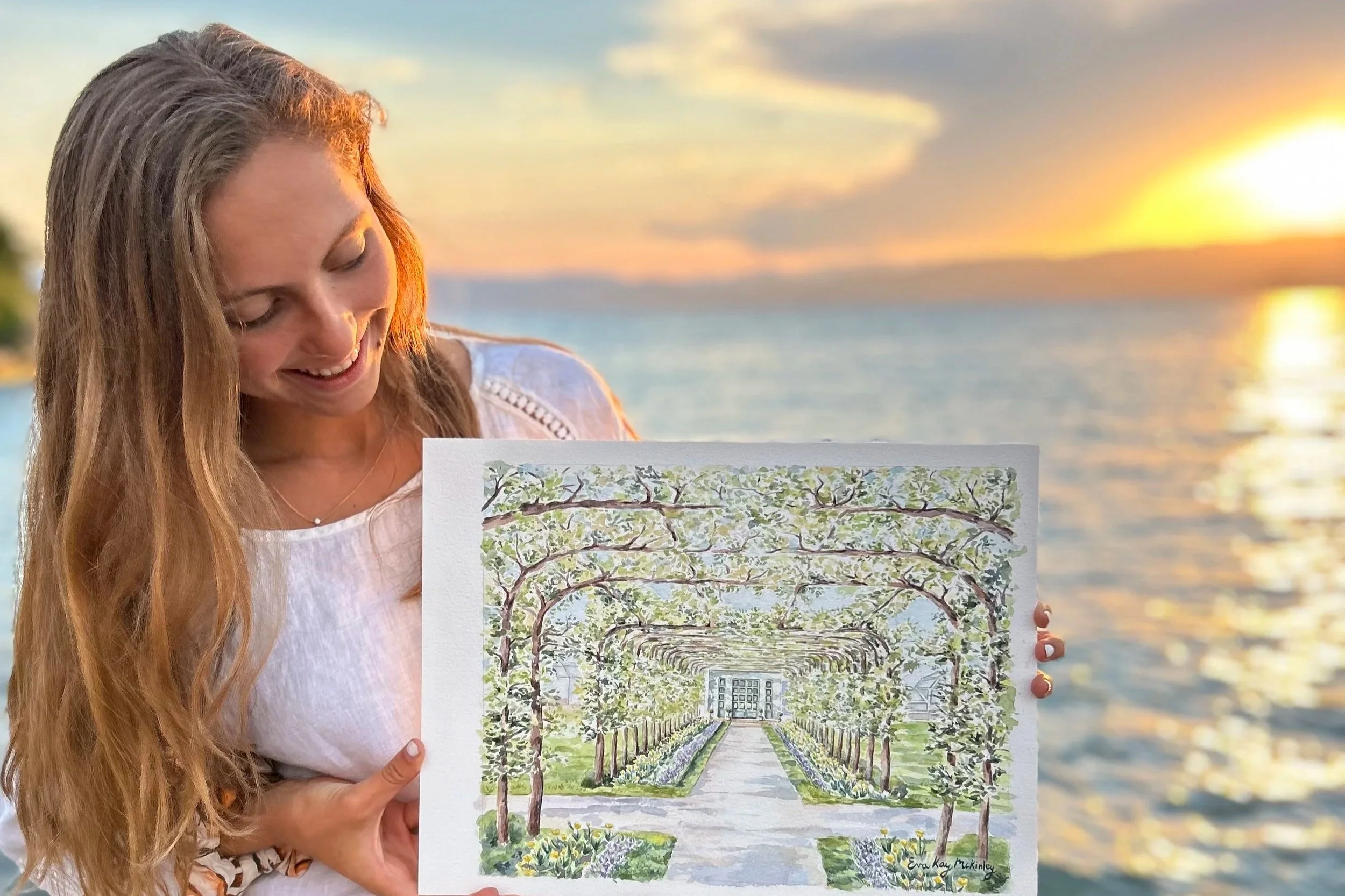 Eva Kay Mckinley holding artwork