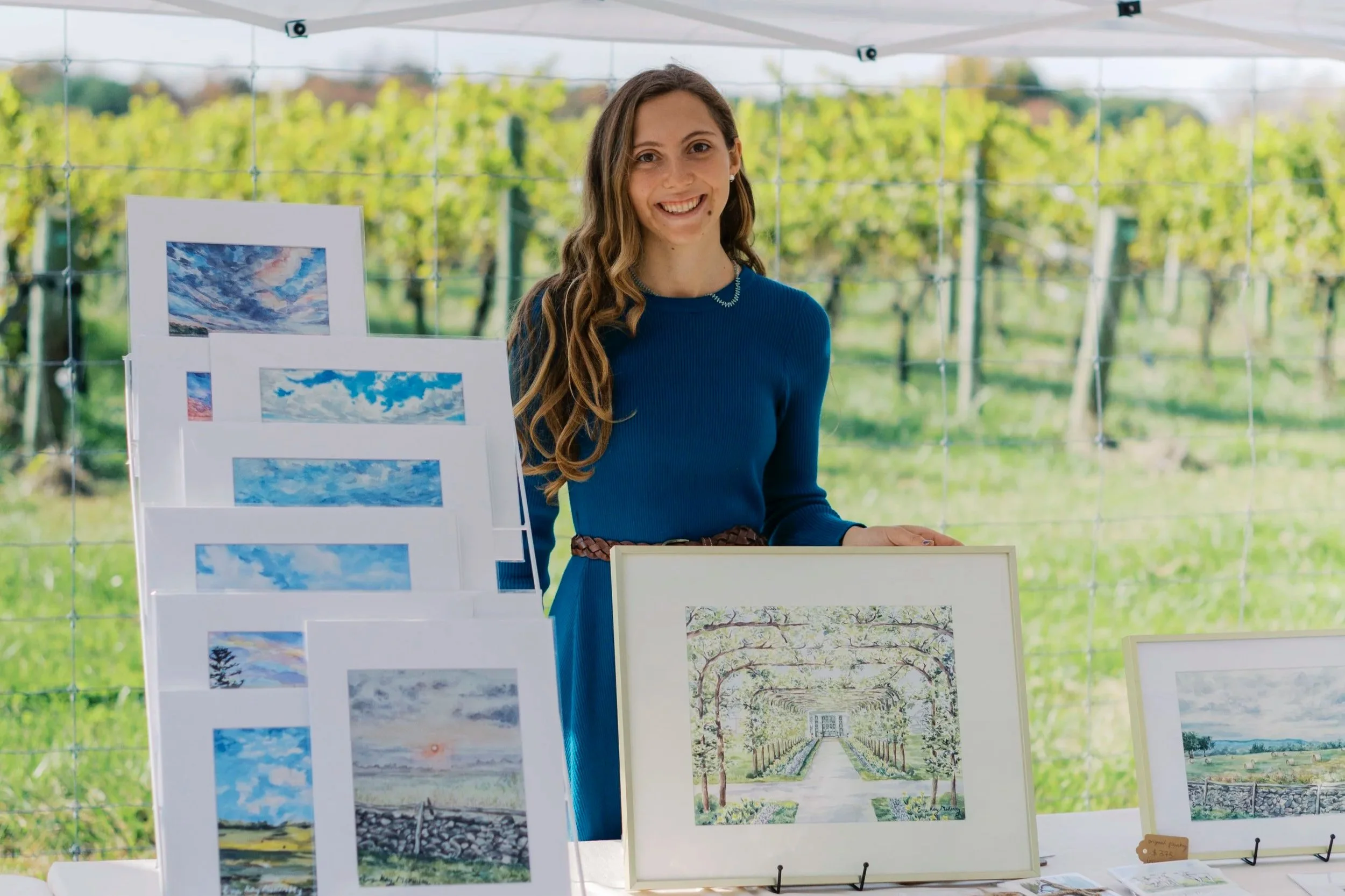 Eva Kay Mckinley holding artwork