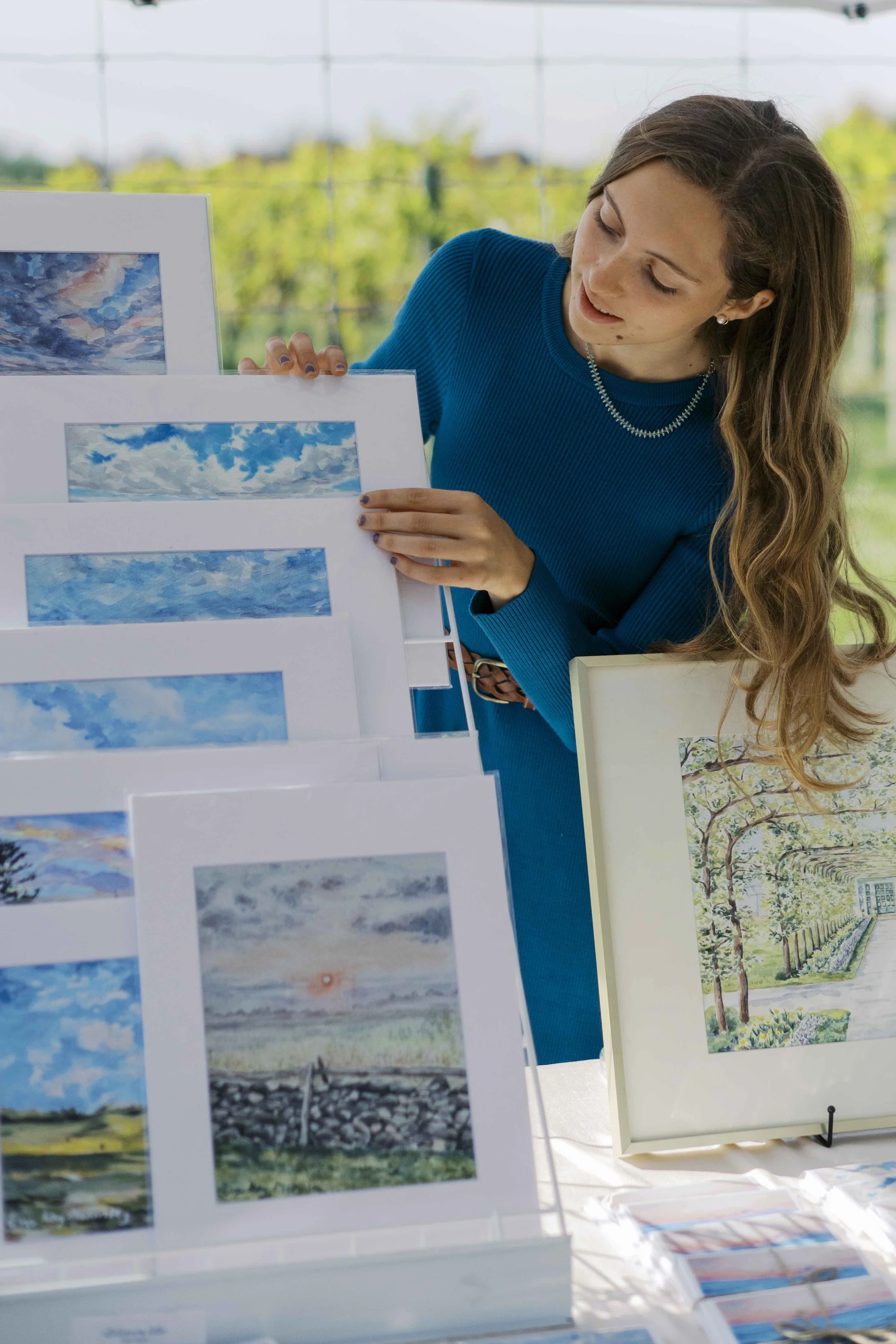 Eva Kay Mckinley holding artwork