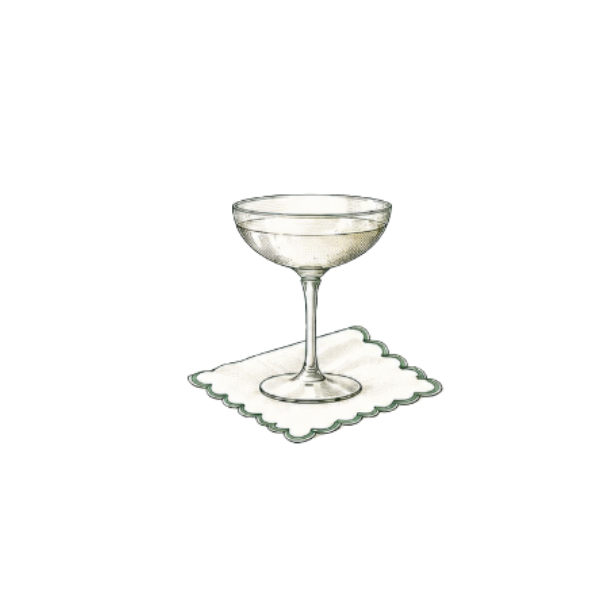 A margarita glass filled with a clear beverage, placed on a cloth napkin.