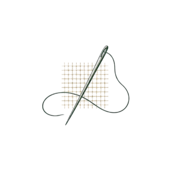 A sewing needle with green thread on a piece of patterned fabric.
