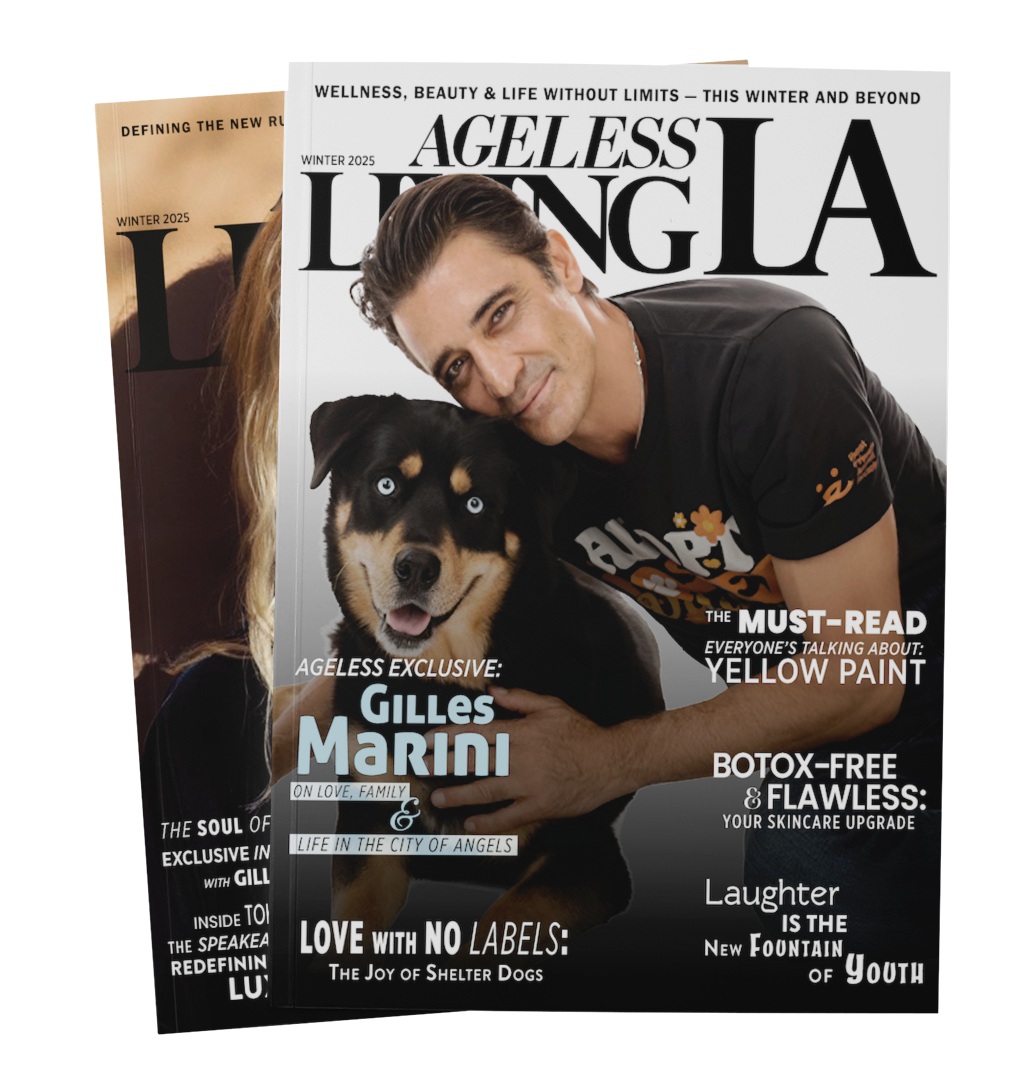 Cover of Ageless Living magazine featuring a man with dark hair smiling and hugging a black and tan dog with blue eyes, against a light background.