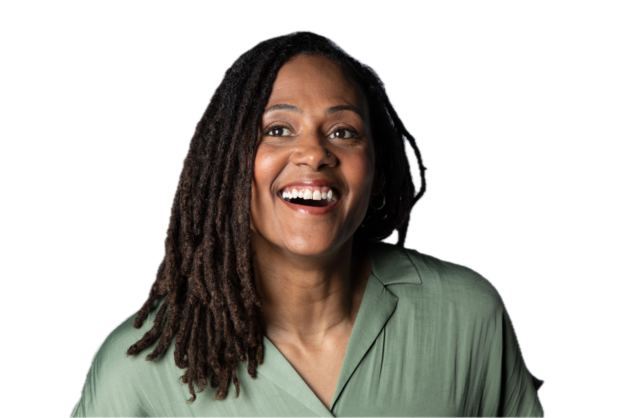 A woman with dark skin and dreadlocks smiling, wearing a green top, with a dark background.