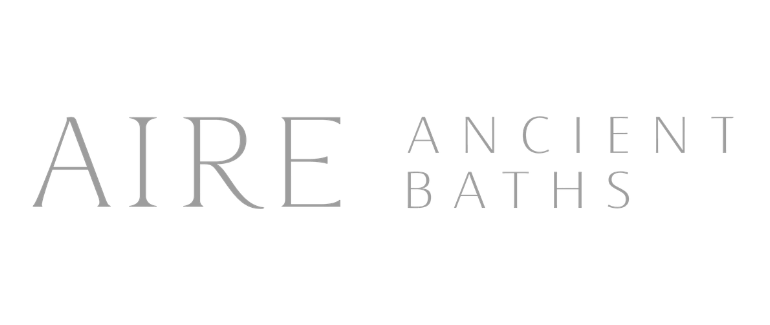 Logo for Aire Ancient Baths with stylized text in gray on a black background.
