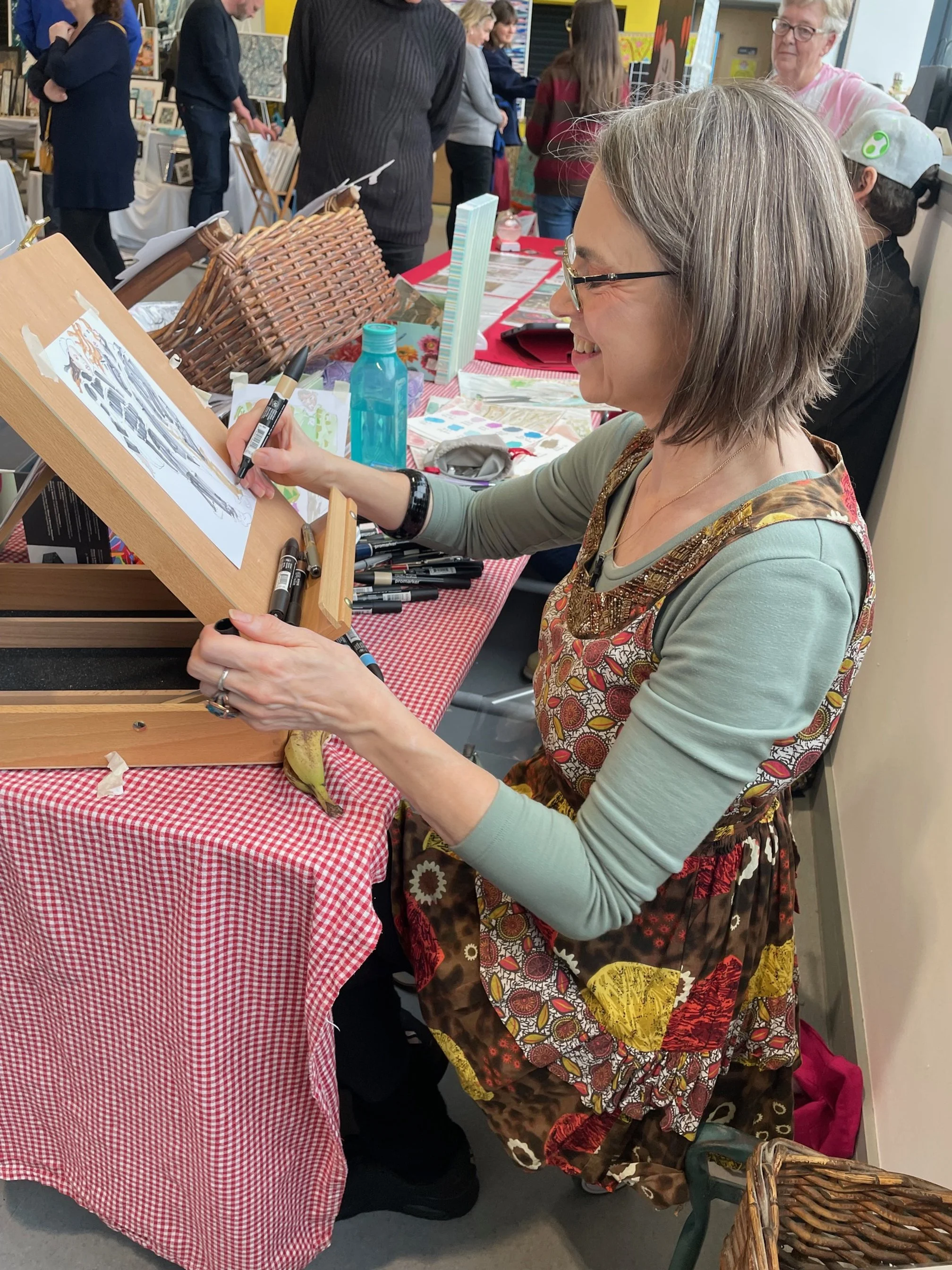 Zoe Parker Illustration at work on a double portrait of guests at a live event in South Croydon.jpg