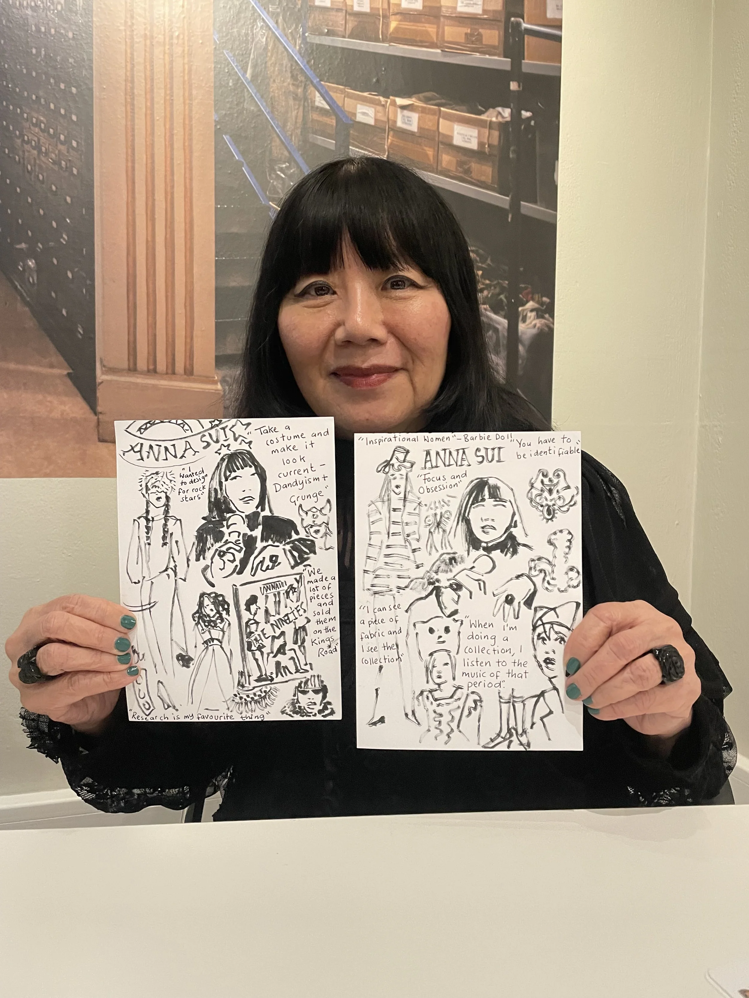 Anna Sui legendary fashion designer best known for nineties fashion designs, holding drawings that I created for her. My drawings of Anna Sui and her fashion designs and quotes from Anna Sui. Line drawings of Anna Sui and her work created by Zoe Park