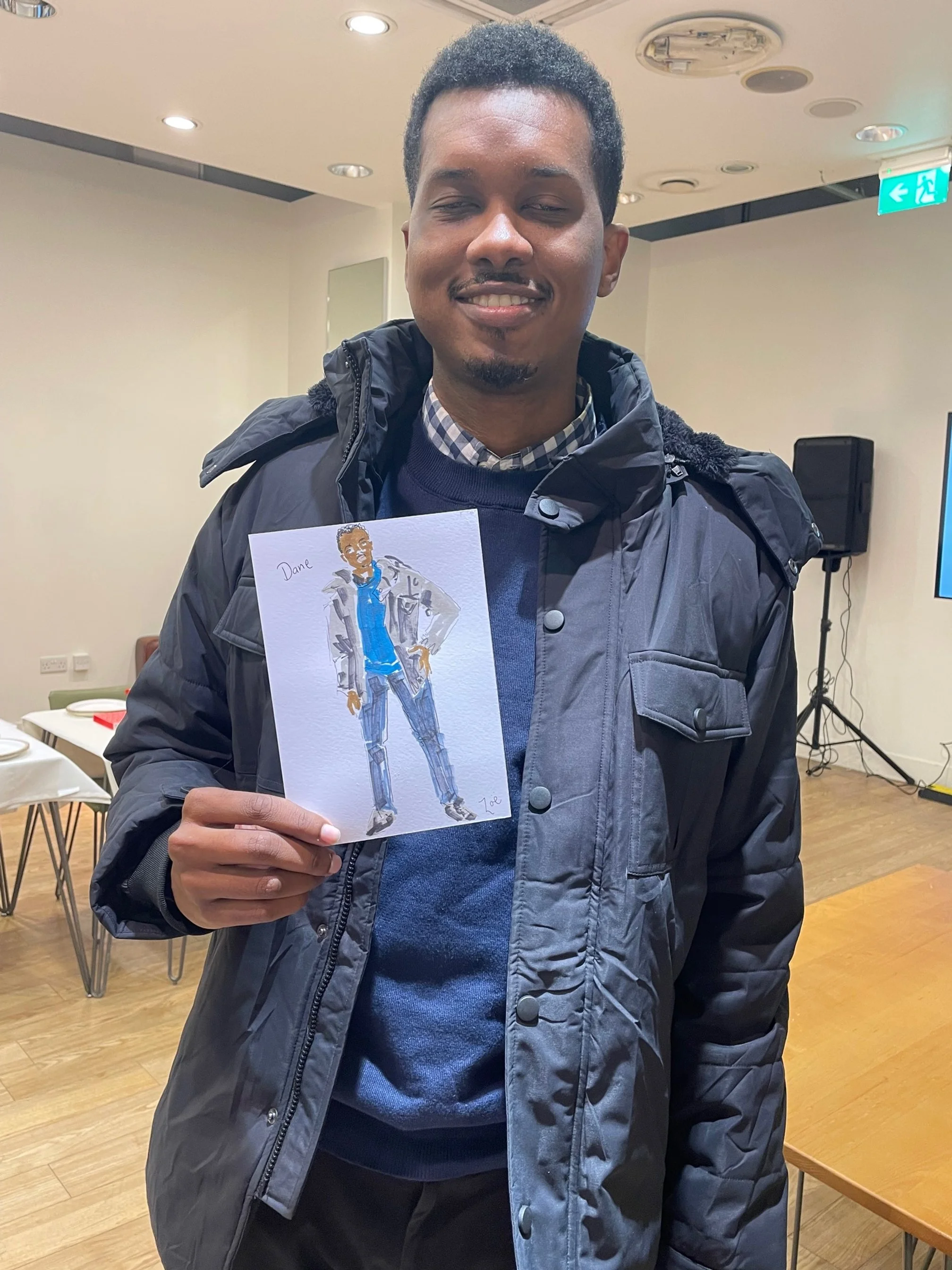 A guest proudly holding live fashion illustration.jpg