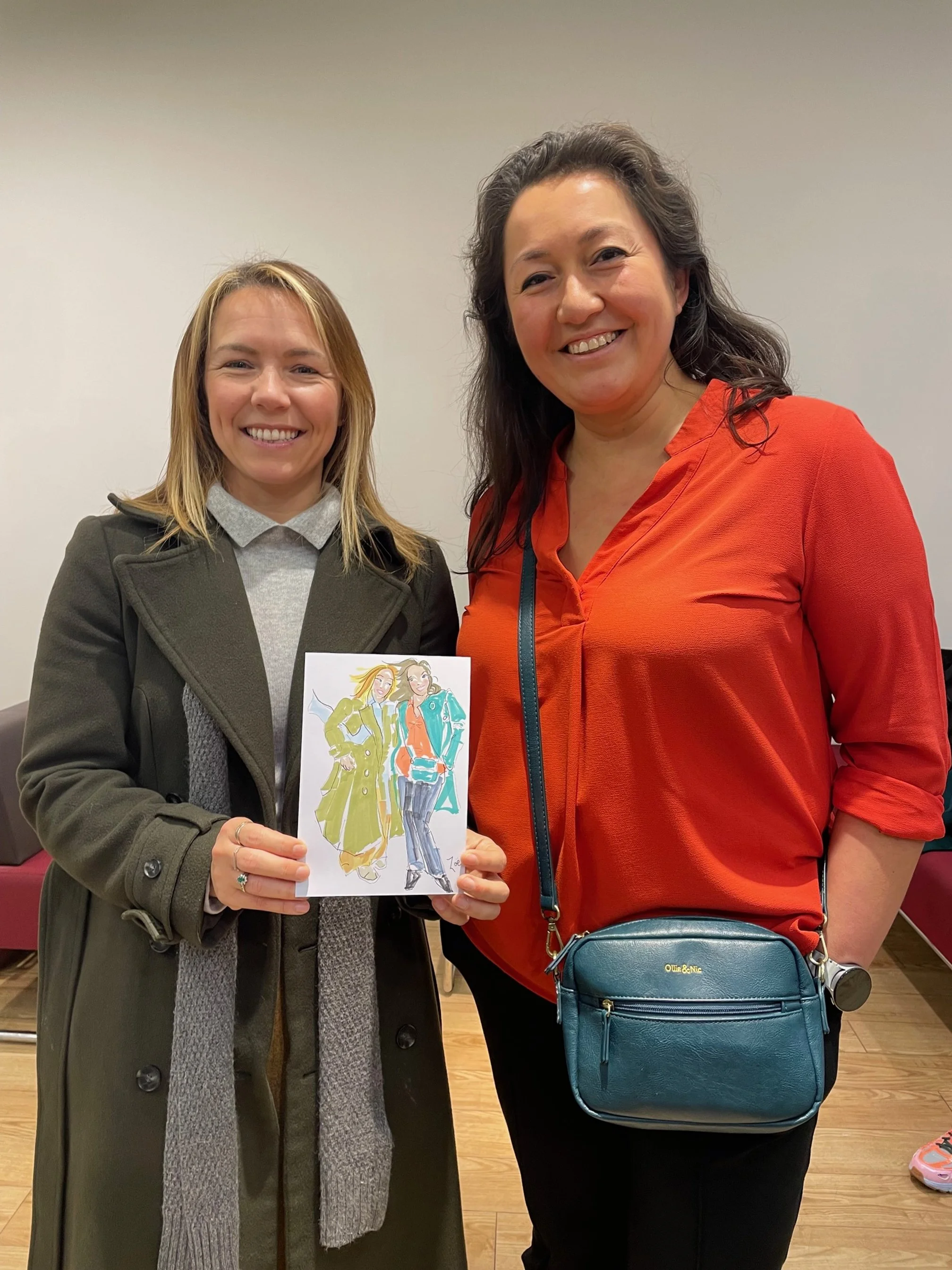 Two guests pose with live fashion illustrations.jpg