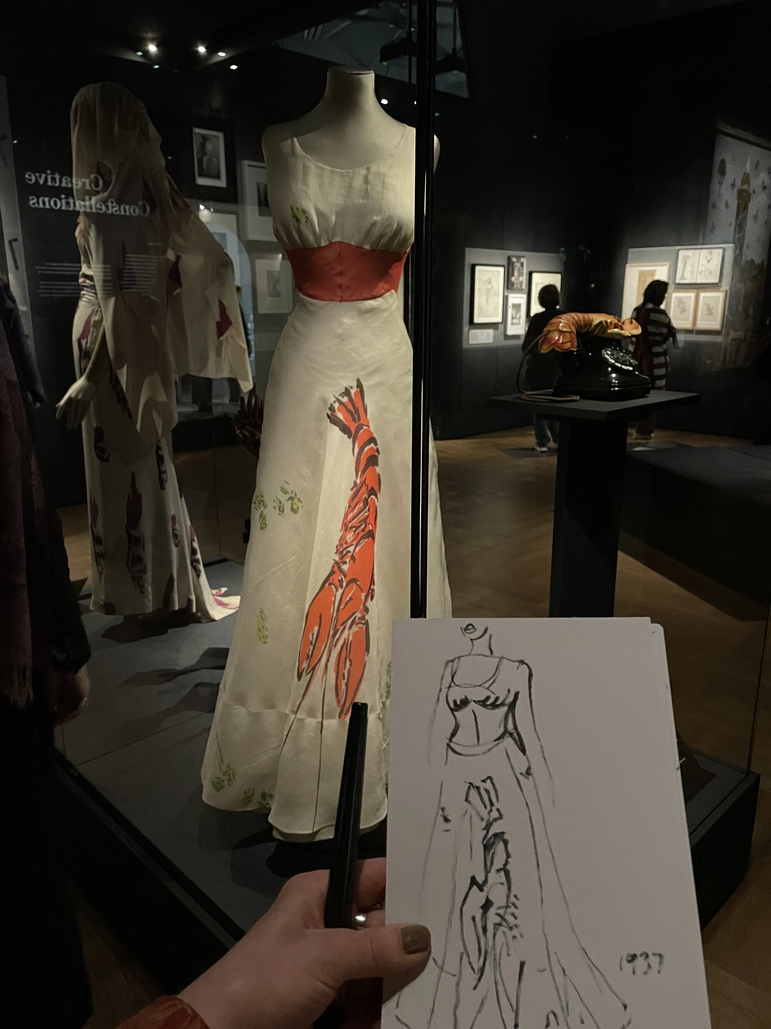 Schiaparelli photo of my outline sketch of lobster dress at exhibition photo by Zoe Parker Illustration.JPEG
