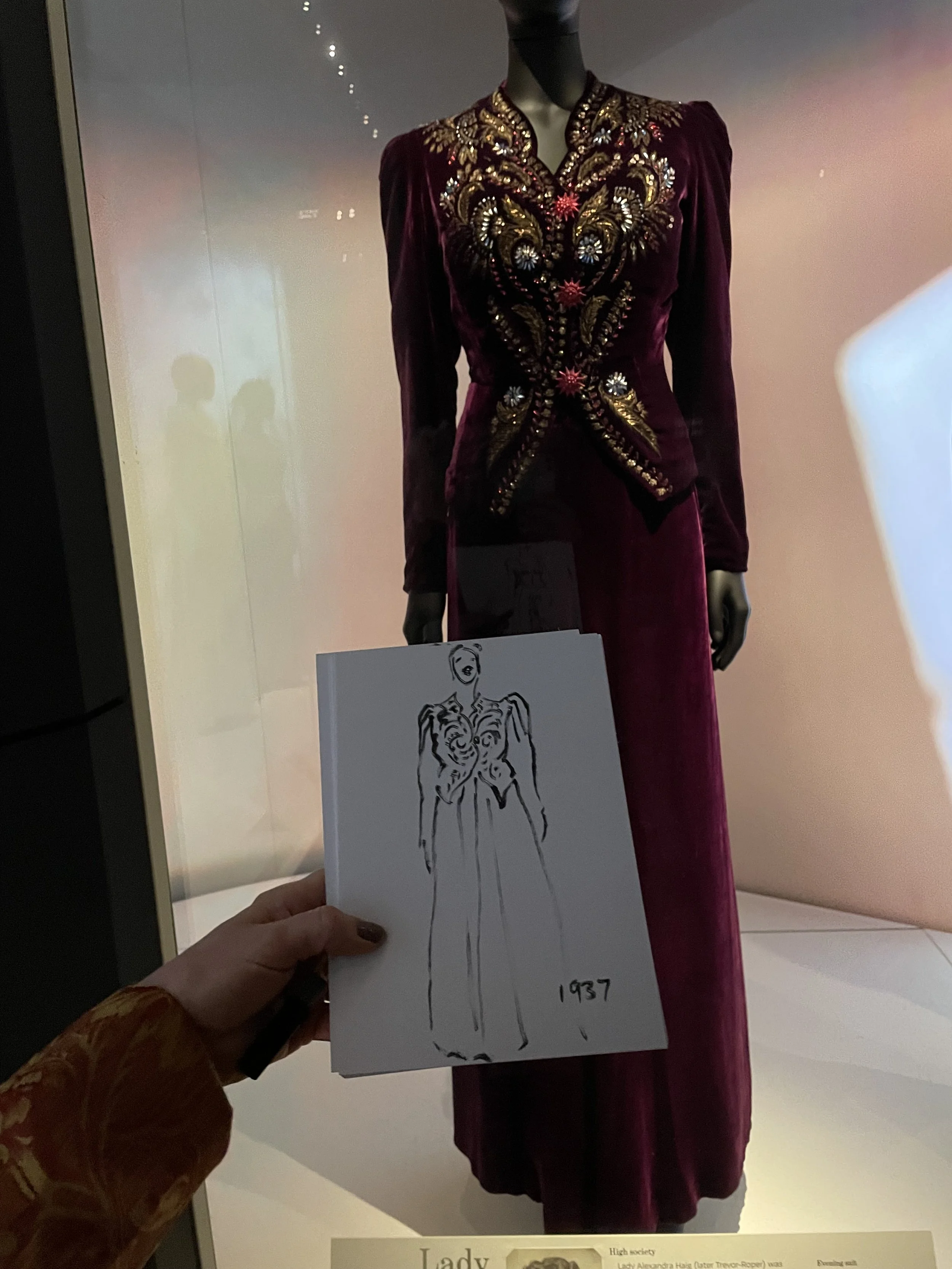 Schiaparelli photo of my outline sketch in front of embroidered jacket photo by Zoe Parker Illustration.JPEG
