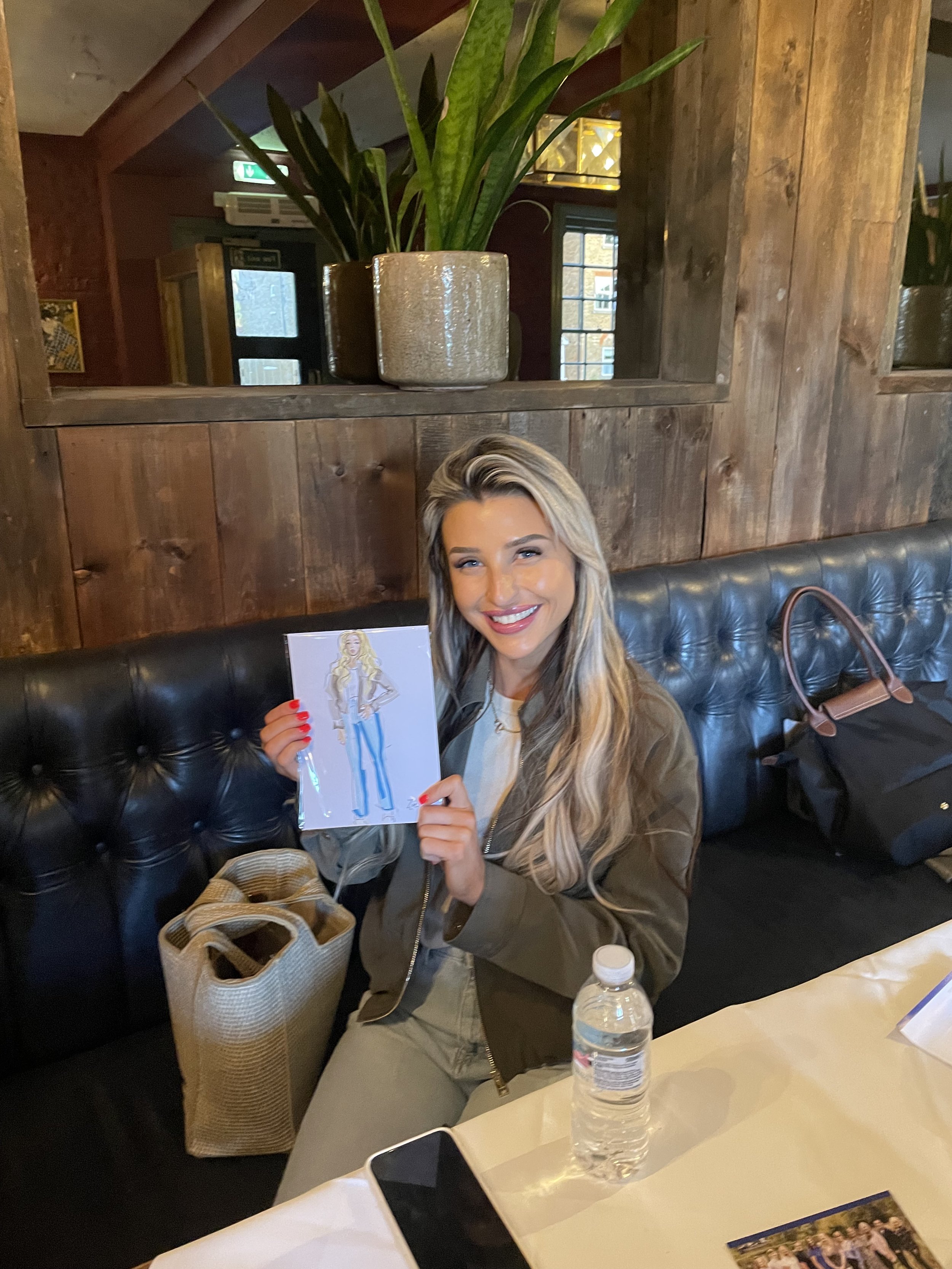Happy customer proudly holds live illustration by Zoe Parker illustration at event by Bells Accountants.JPEG