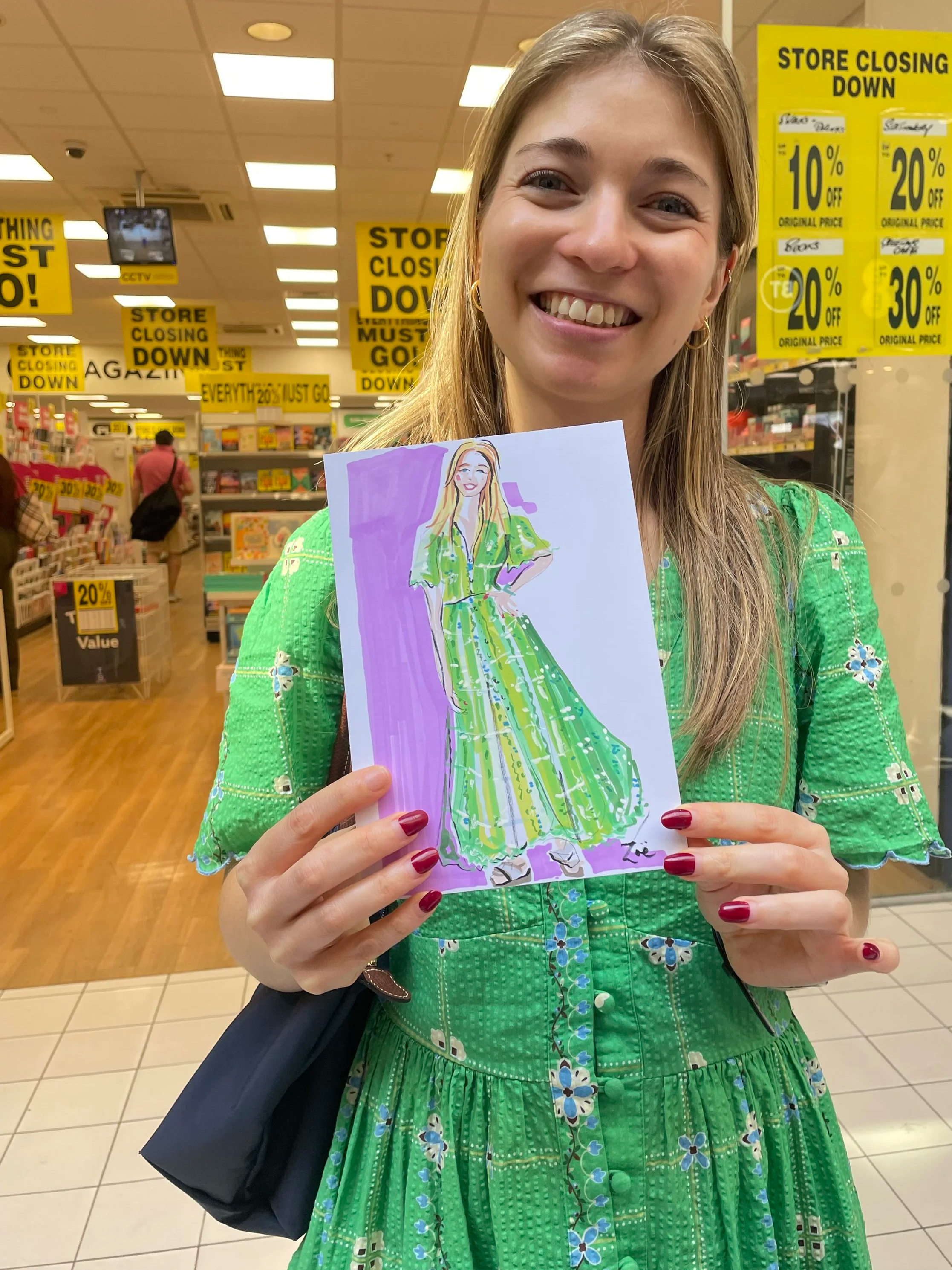 Live illustration of happy client at Wimbledon Quarter, holding drawing by Zoe Parker Illustration