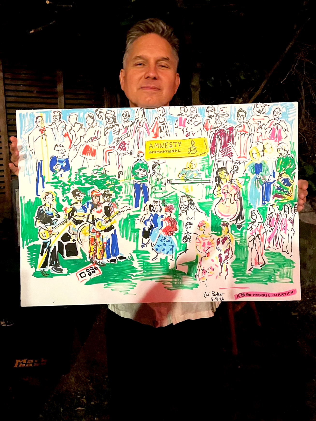 Jonny Quinn from Snow Patrol holding his live illustration by Zoe Parker Illustration, of the Amnesty International drawing.