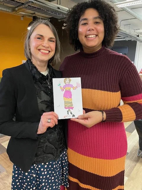 Zoe Parker Illustration with happy customer holding a live illustration portrait at an event which Zoe Parker Illustration was illustrating at.