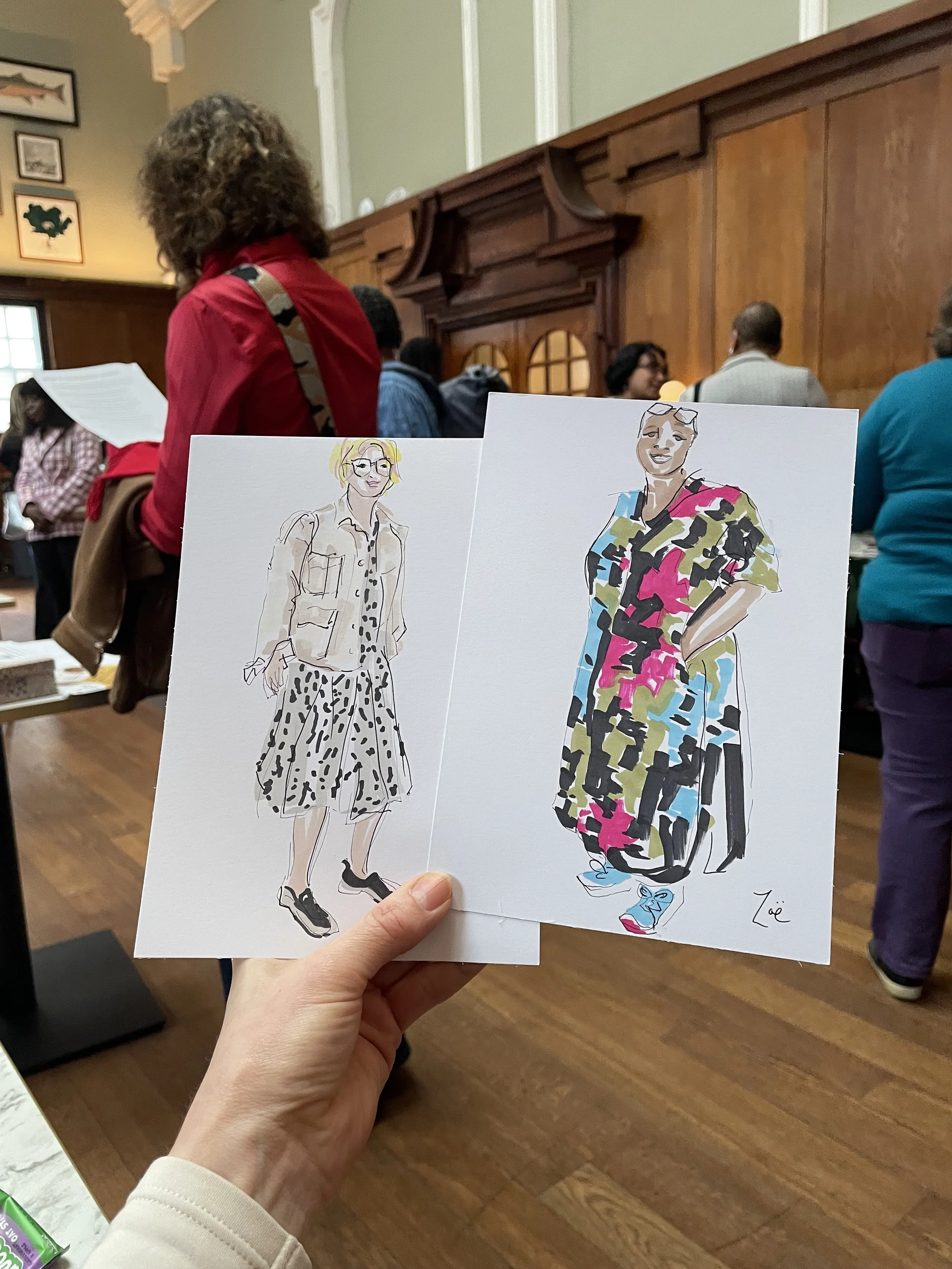 Zoe Parker Illustration holding two drawings created live at Bromley Ladies Who Latte