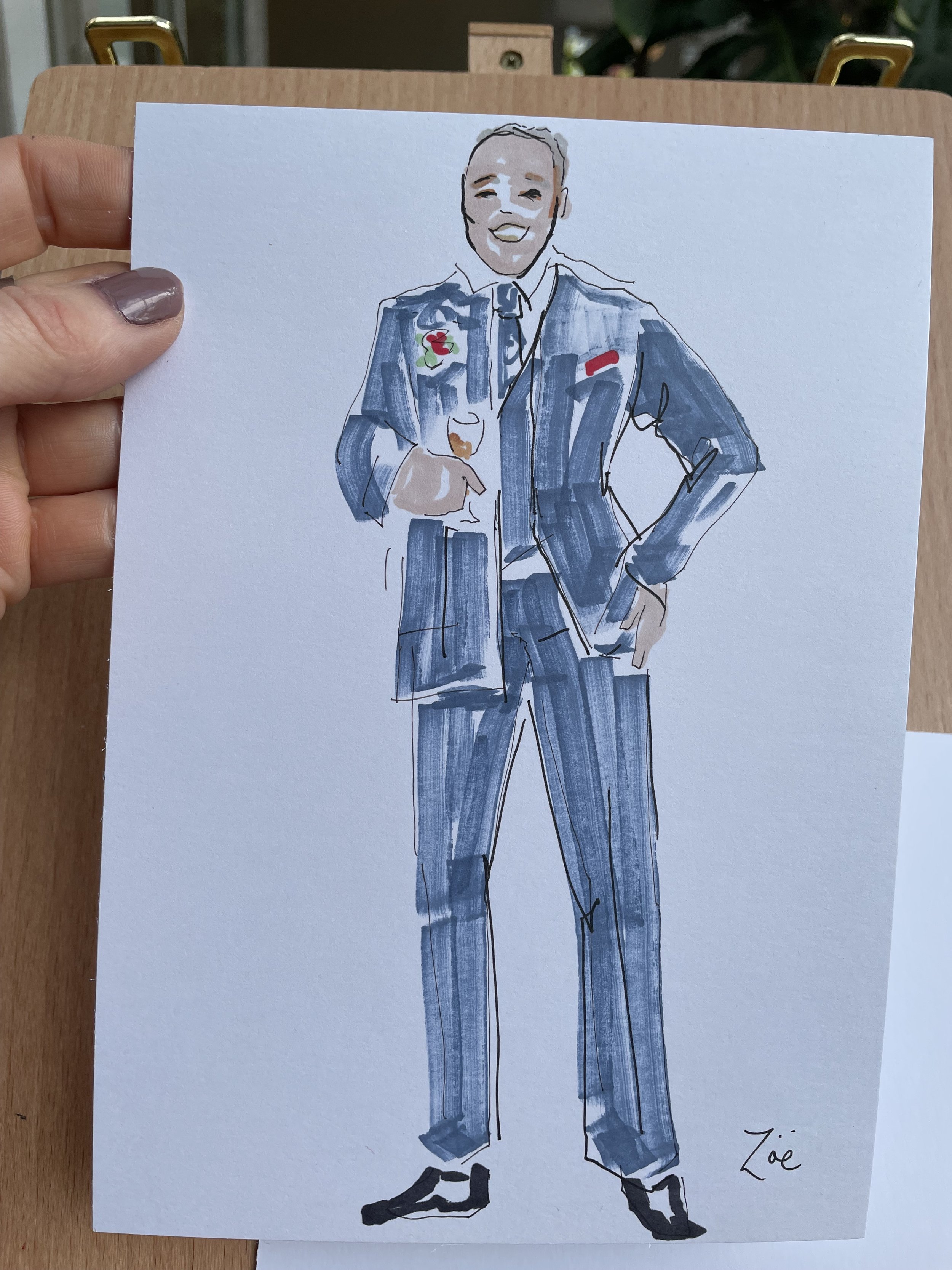 Live wedding illustration by Zoe Parker Illustration of the father of the bride wearing a blue suit and a floral buttonhole and carrying a glass of champagne