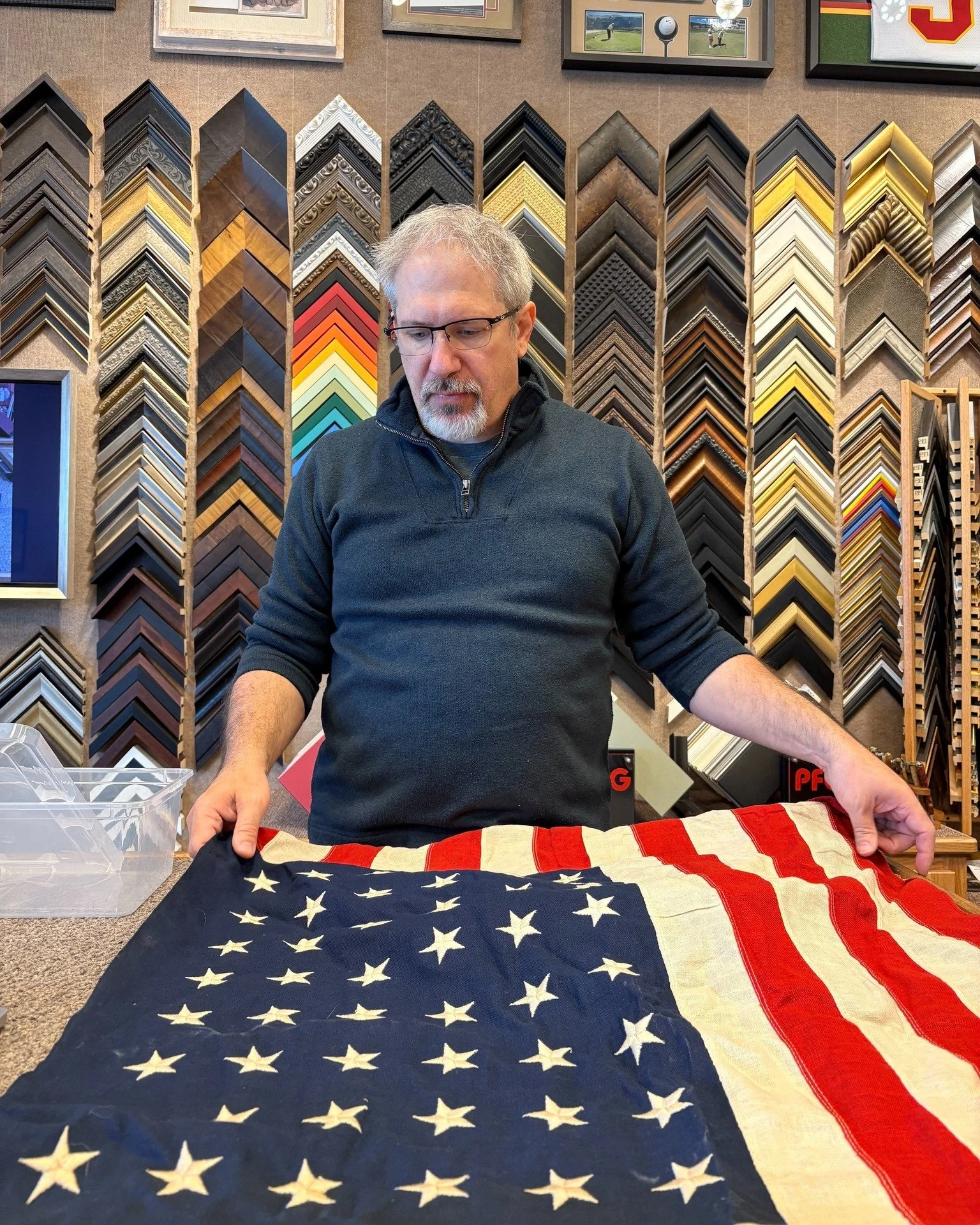 Framing this old flag with 48 stars. Though the flag is thin from age, it is still in excellent condition -- and we are going to make sure it stays that way!