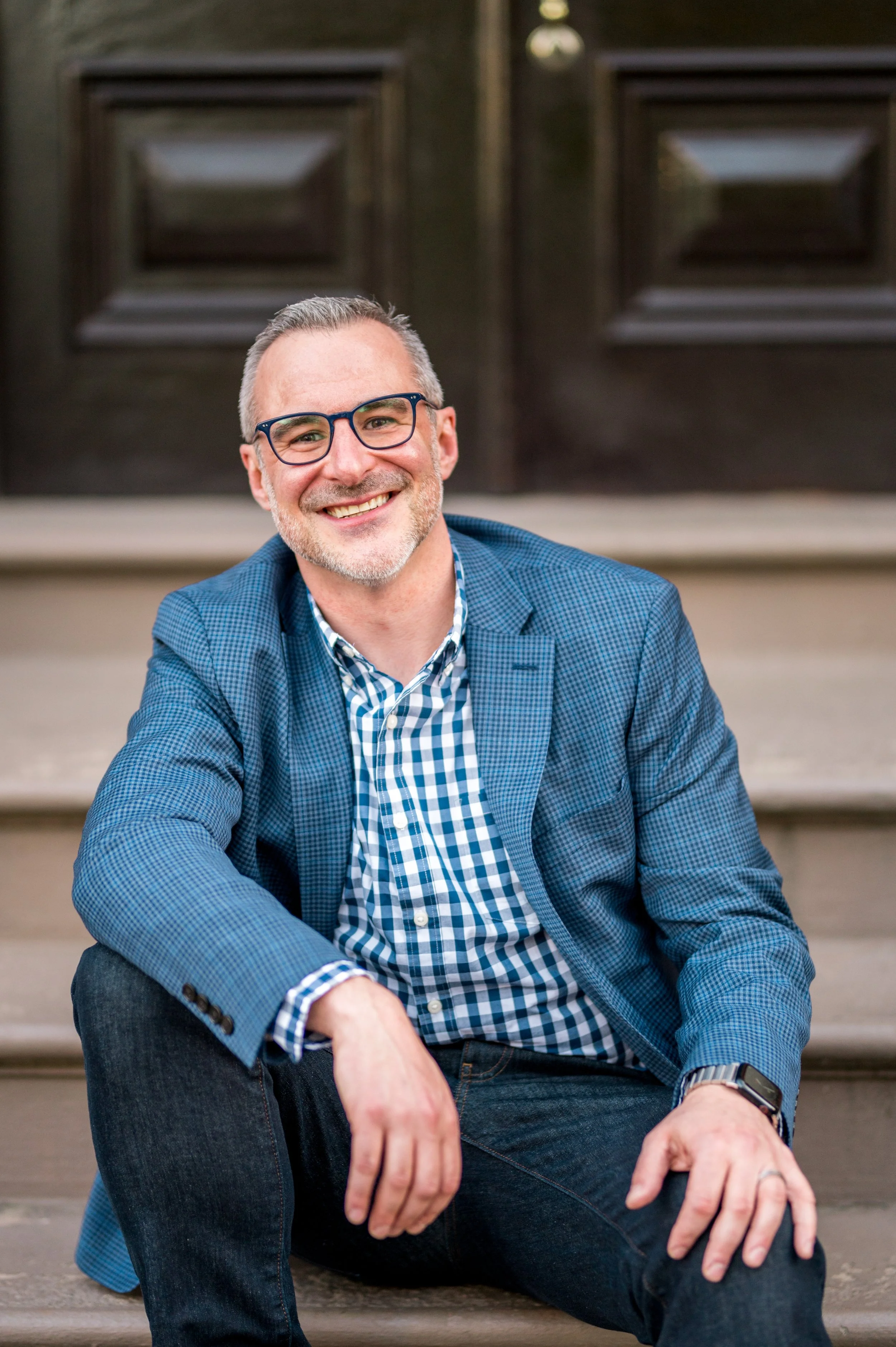 Dan sitting down and smiling for the camera