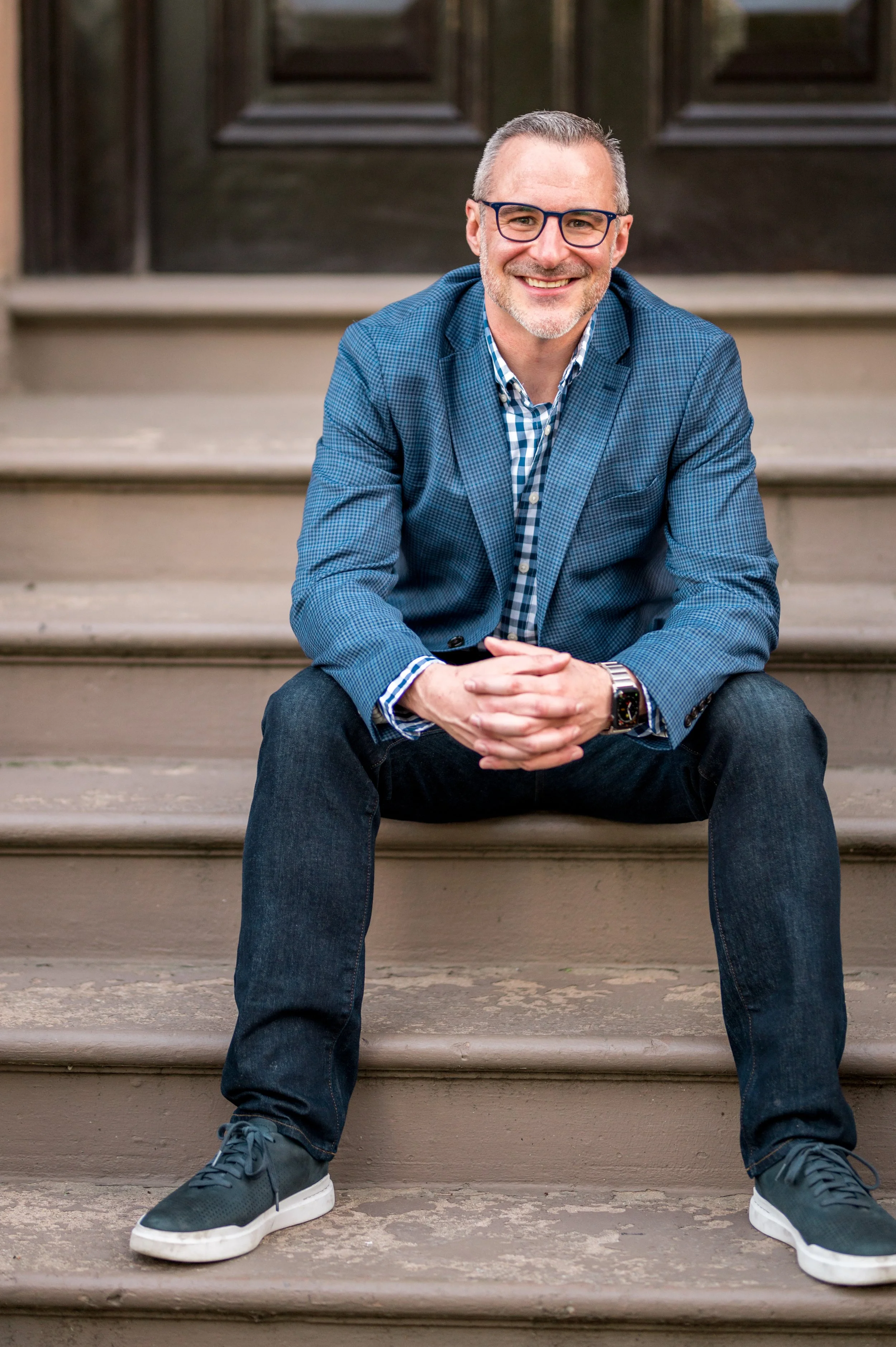 Dan sitting on a stoop in Boston