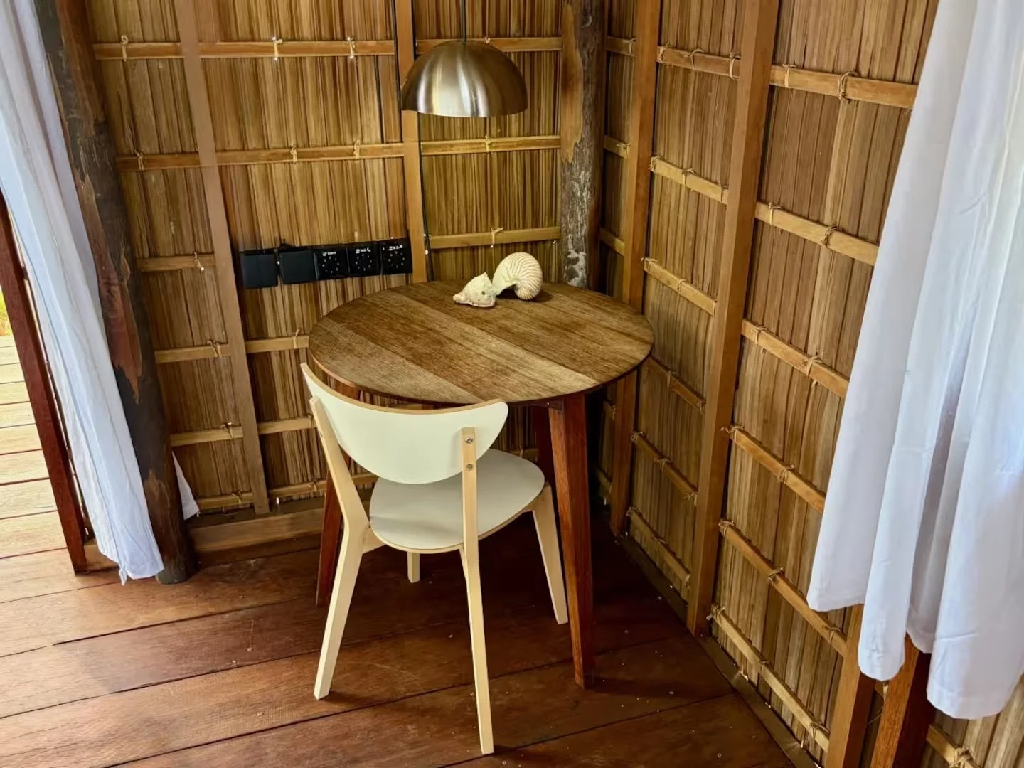 Desk with lamp and international power outlets in premium beach guest house at ipyum.jpeg