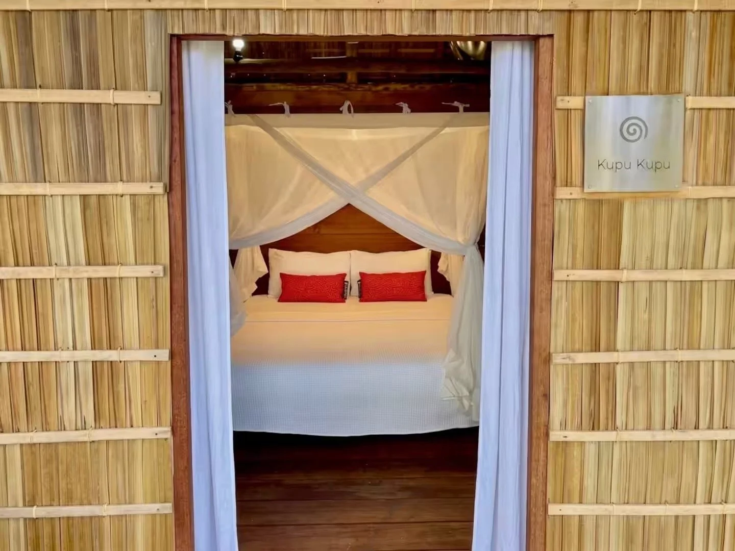 Step in from the terrace to a comfortable king canopy bed in your natural beach guest house.jpeg