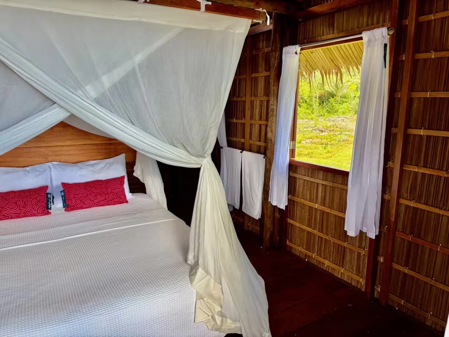 Linen curtains and two windows let in soft sunshine and fresh tropical air.jpeg