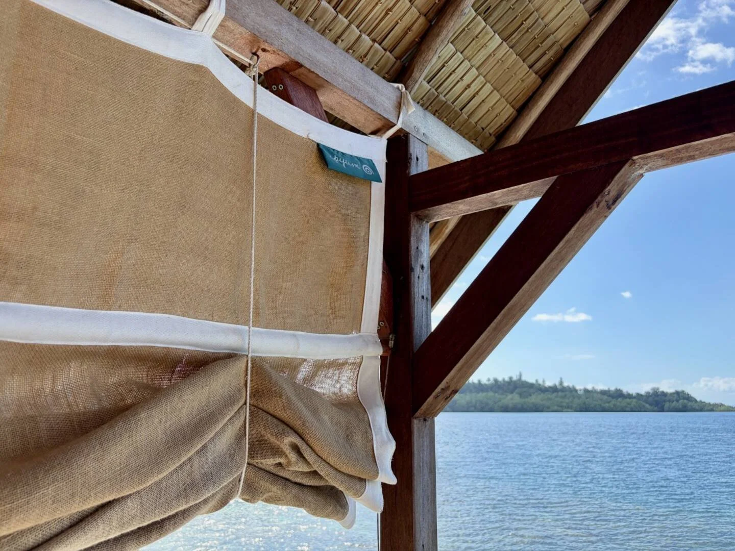 Custom privacy curtains on the overwater guest house terrace at ipyum.jpeg