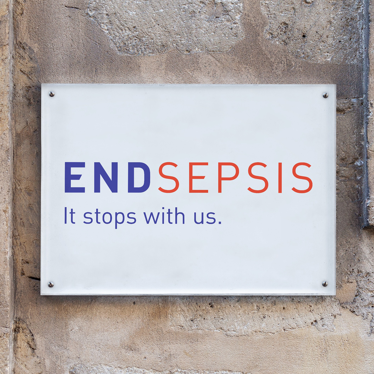 Sign reading 'END SEPSIS It stops with us.' on a textured wall.