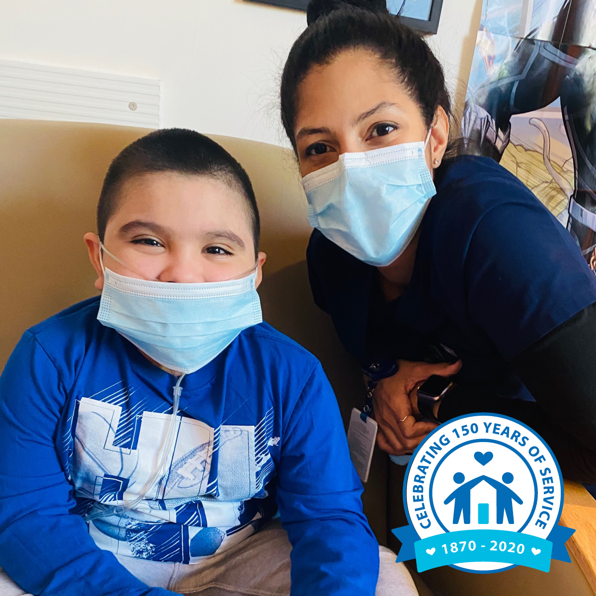 A child and a healthcare worker smiling while wearing face masks. There's a badge in the corner that reads, "Celebrating 150 Years of Service 1870-2020."