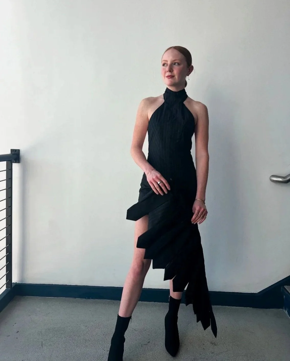 Backless halter neck romper with removable back chain and hook and eye mini skirt. Made with pinstripe wool suiting fabric, gold hook and eye closures, hidden snaps, invisible side zipper, and gold rings.