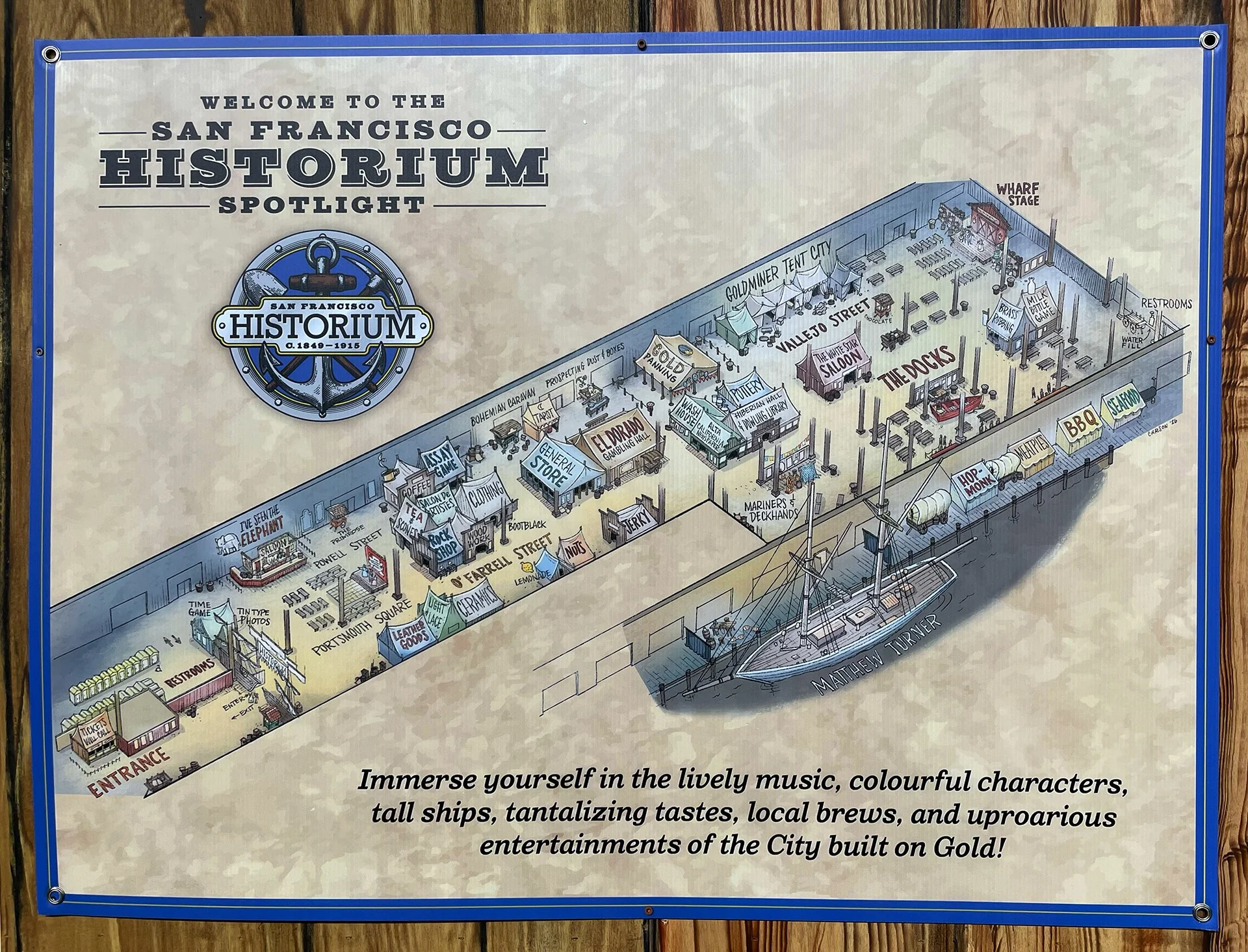 A large sign showing a detailed map of the San Francisco Historium, showing various market stalls, entertainment areas, and facilities, with a yacht docked at the pier.