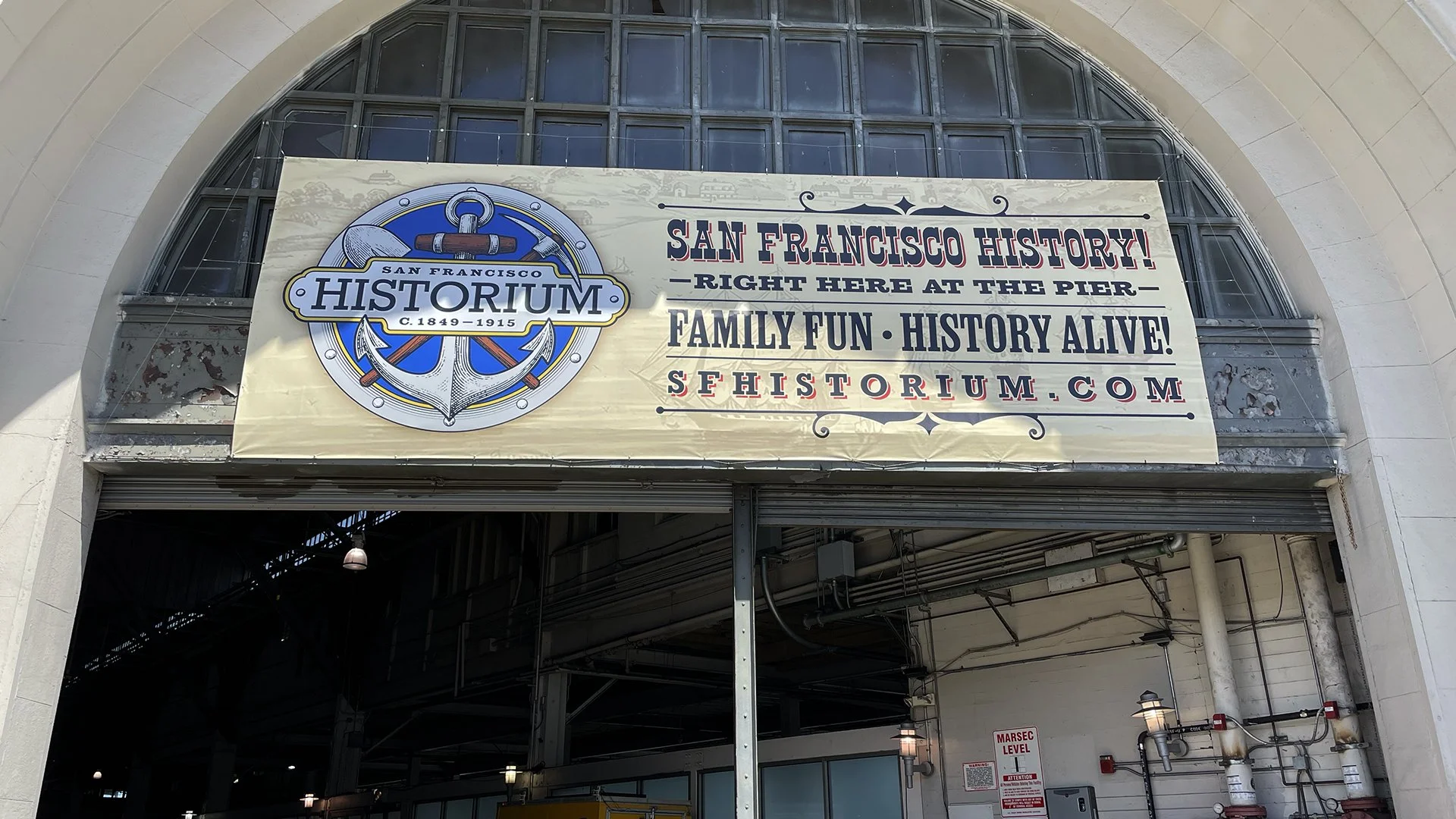 Fabric banner for San Francisco Historium with anchor logo and text promoting family fun and history alive at the pier.
