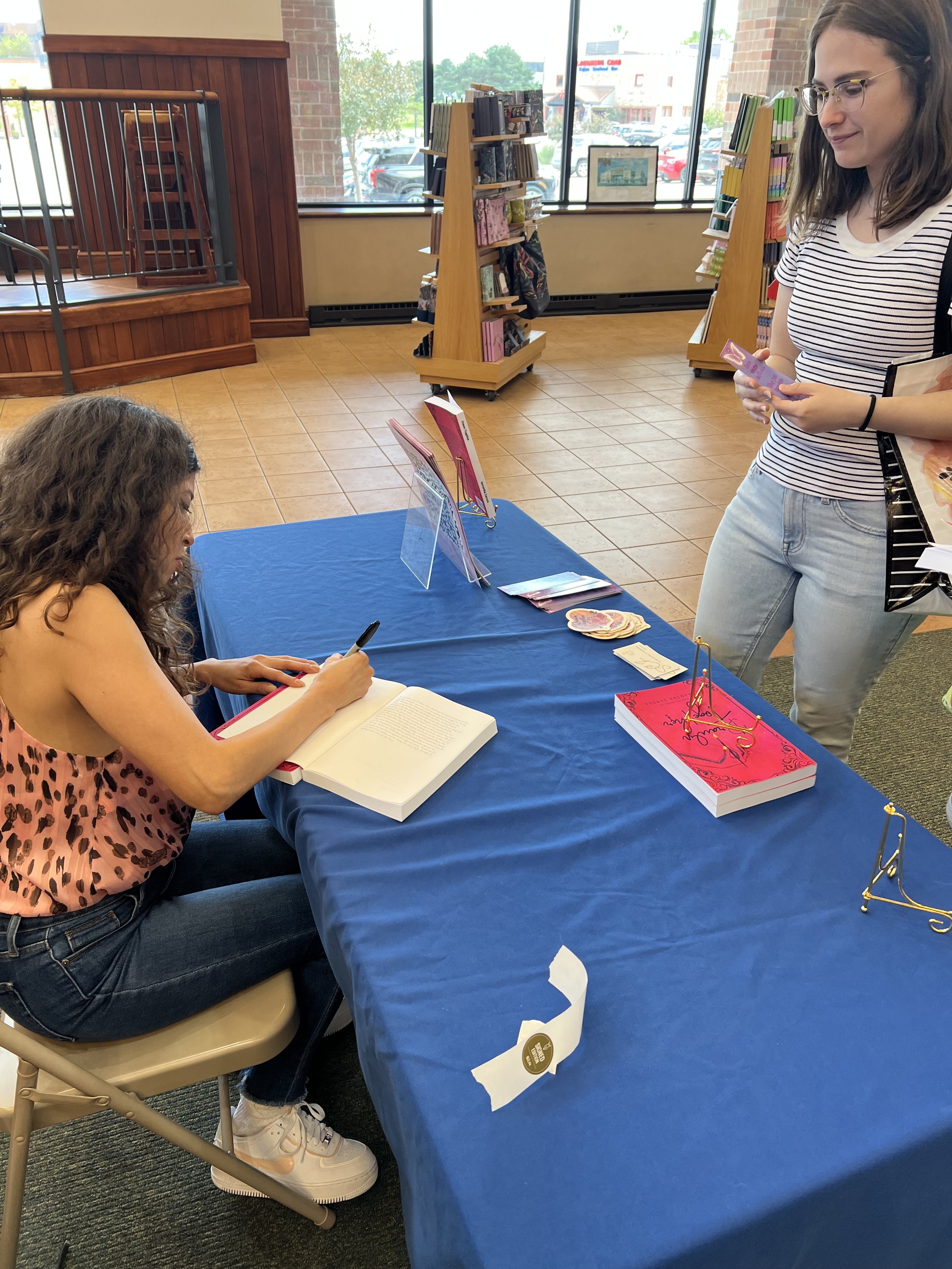 Samantha Zamora signing books for a reader at Barnes & Noble in Des Moines, Iowa.