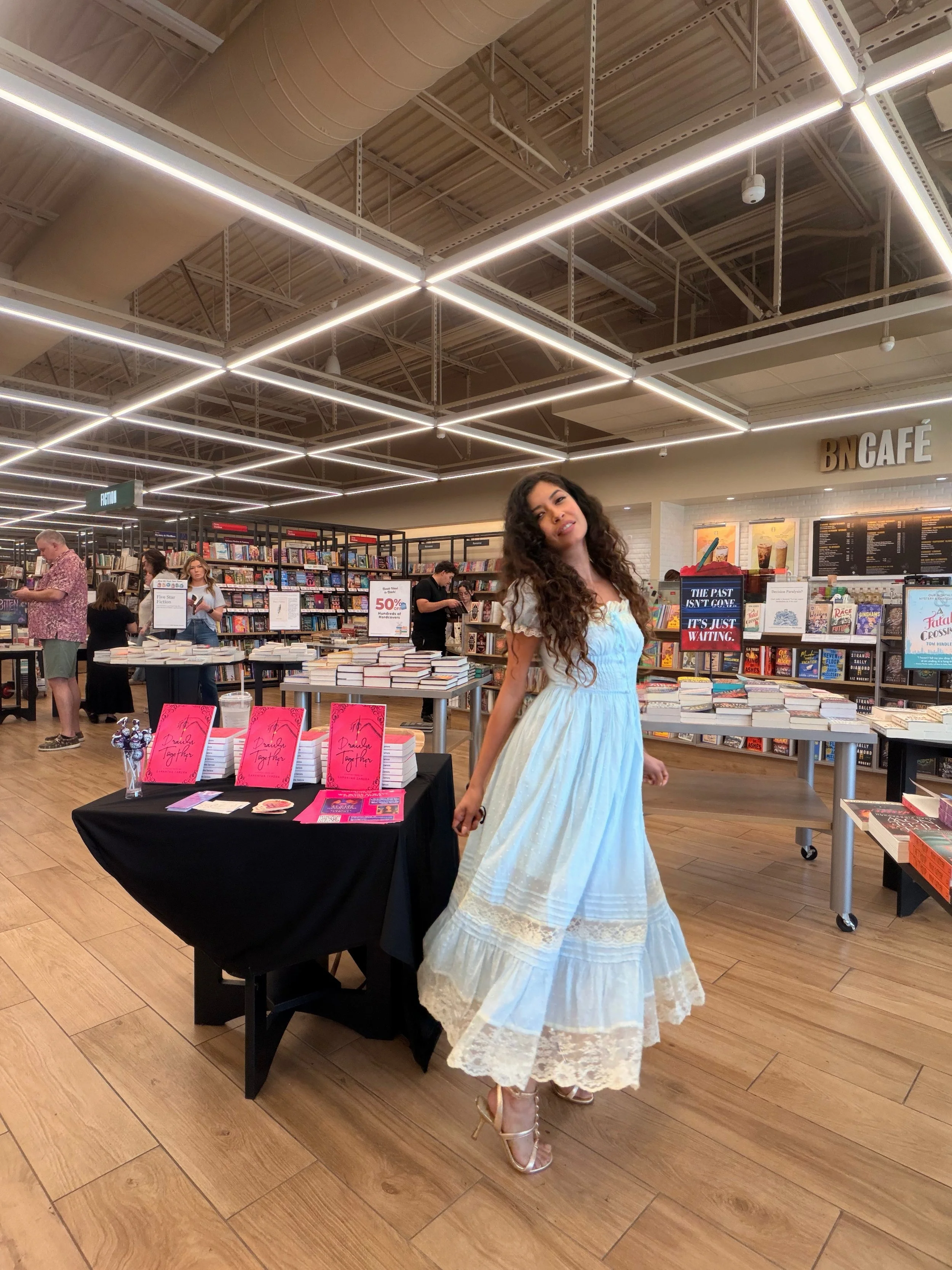 Samantha Zamora posing beside her signed books and author display at Barnes & Noble The Veranda in Concord, California.