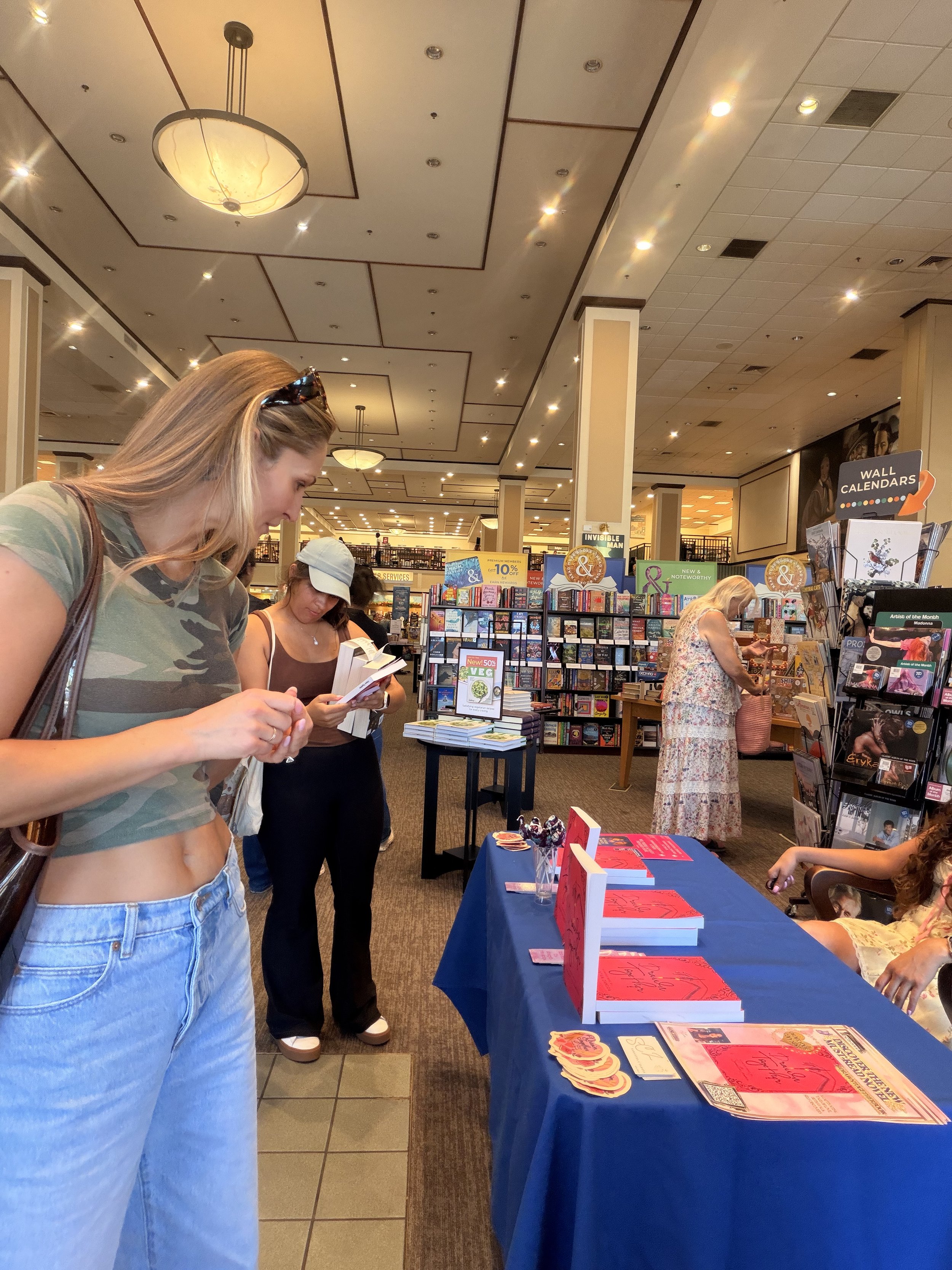A reader visiting Samantha Zamora's signing table and discovering her novels at Barnes & Noble in Westlake Village, California.