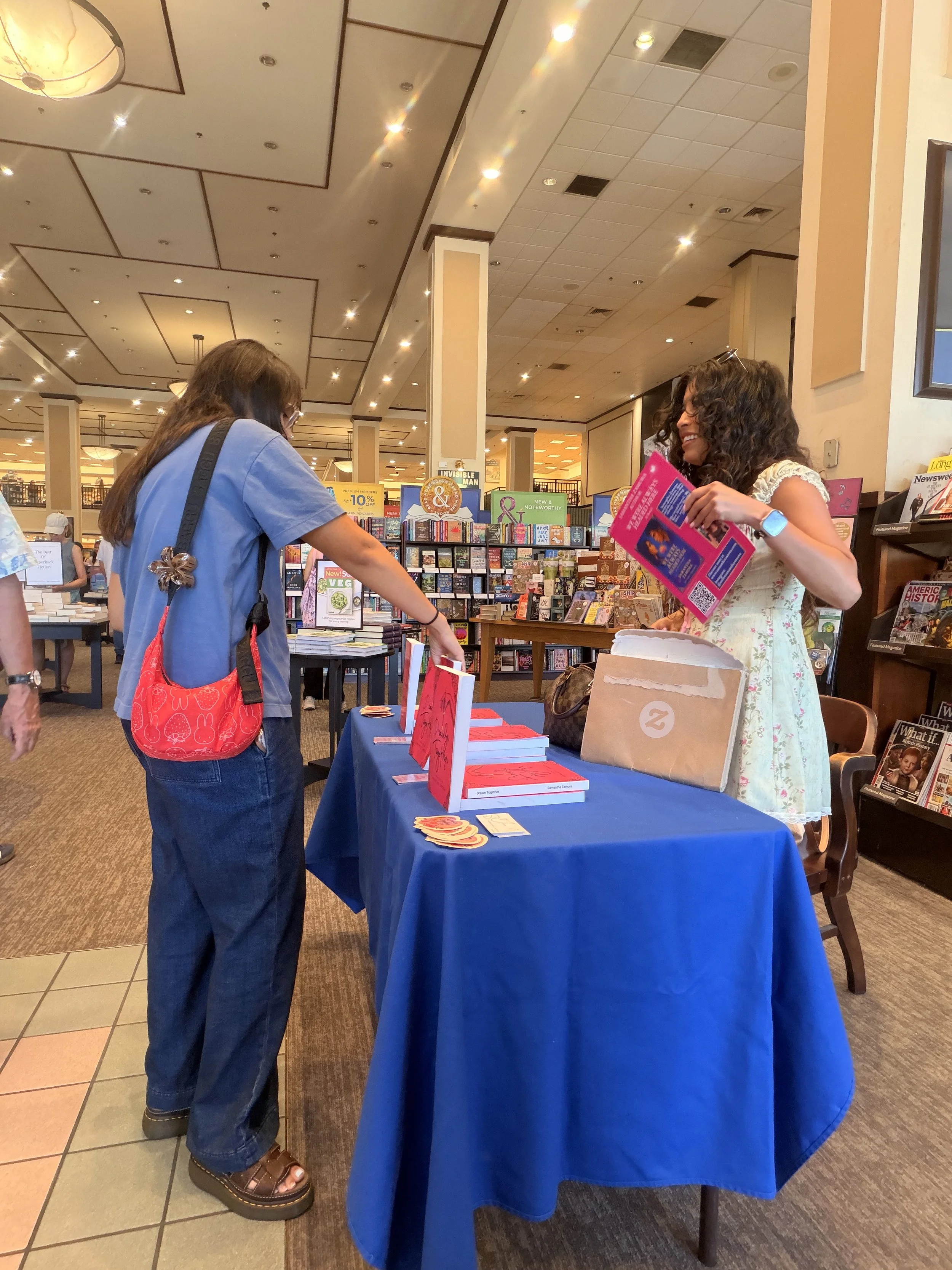 A reader picking up Samantha Zamora's books during her Barnes & Noble signing in Westlake Village, California.