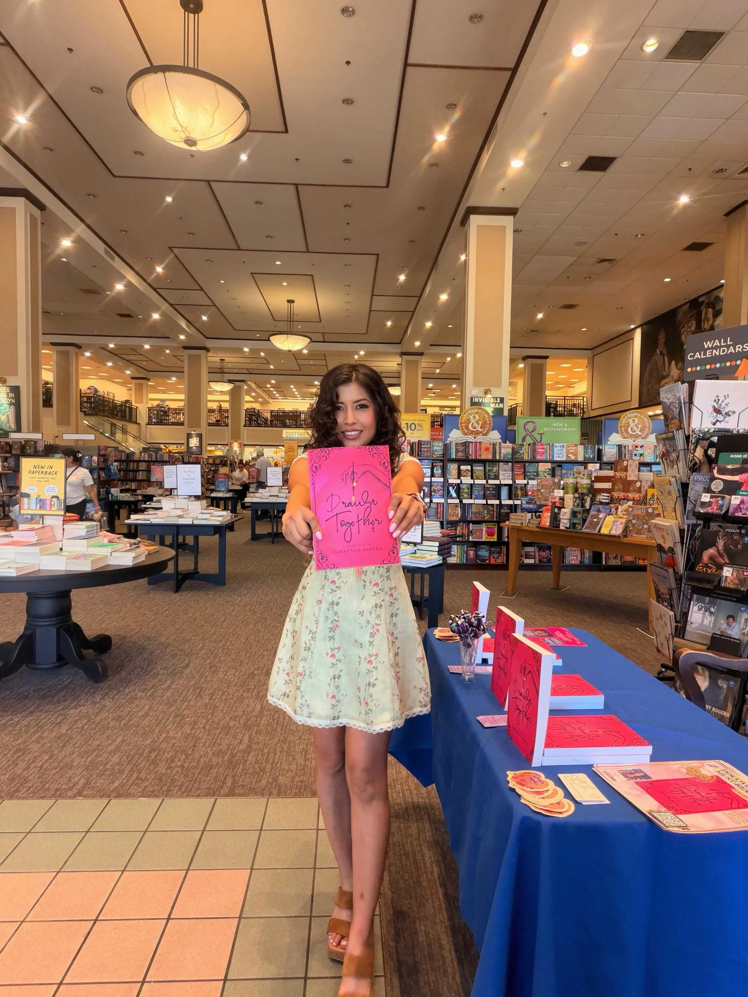 Author Samantha Zamora holding Drawn Together at her Barnes & Noble book signing at The Promenade at Westlake.