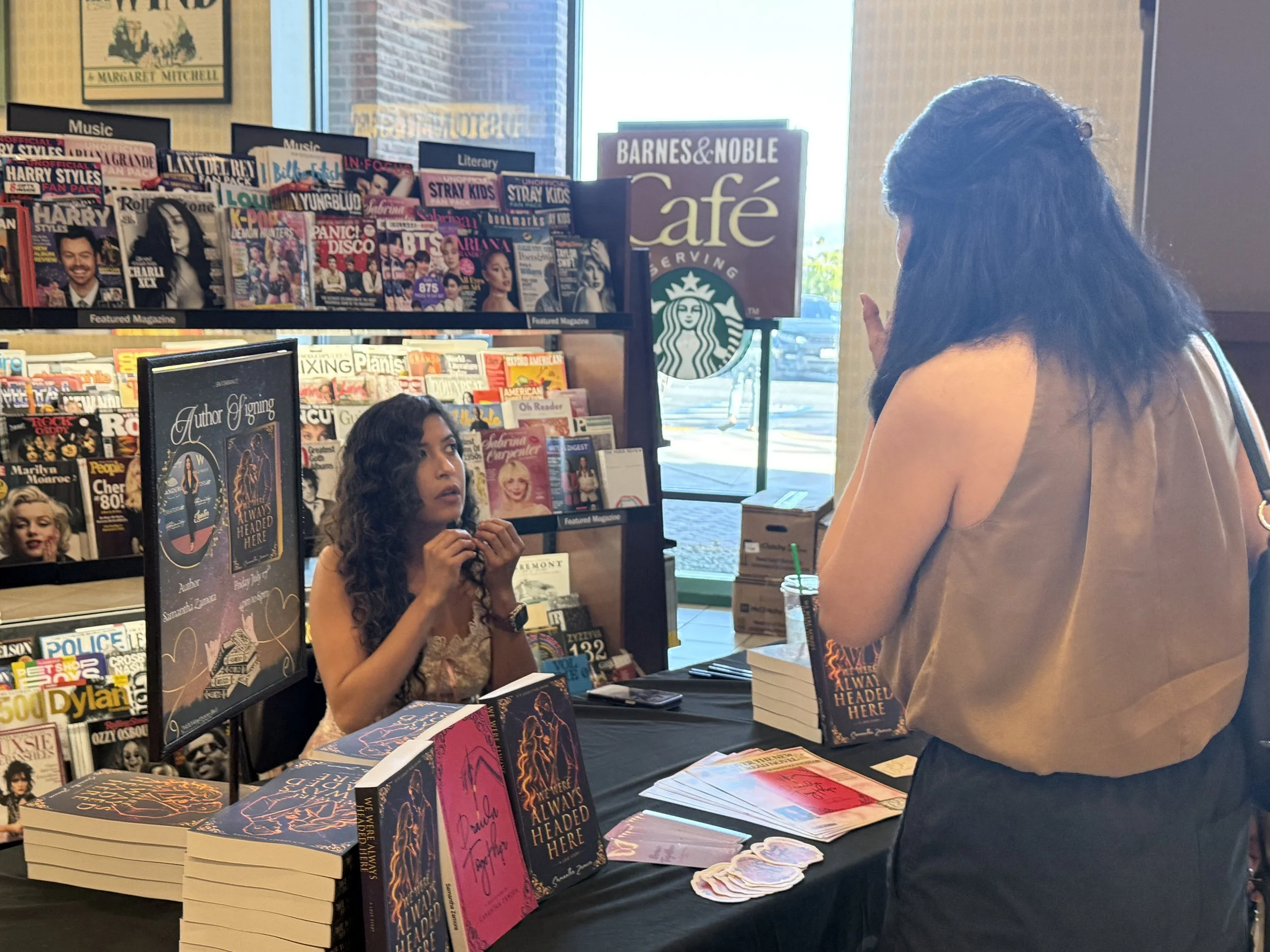 Samantha Zamora signing and personalizing a book for a reader at her Barnes & Noble Torrance author event.