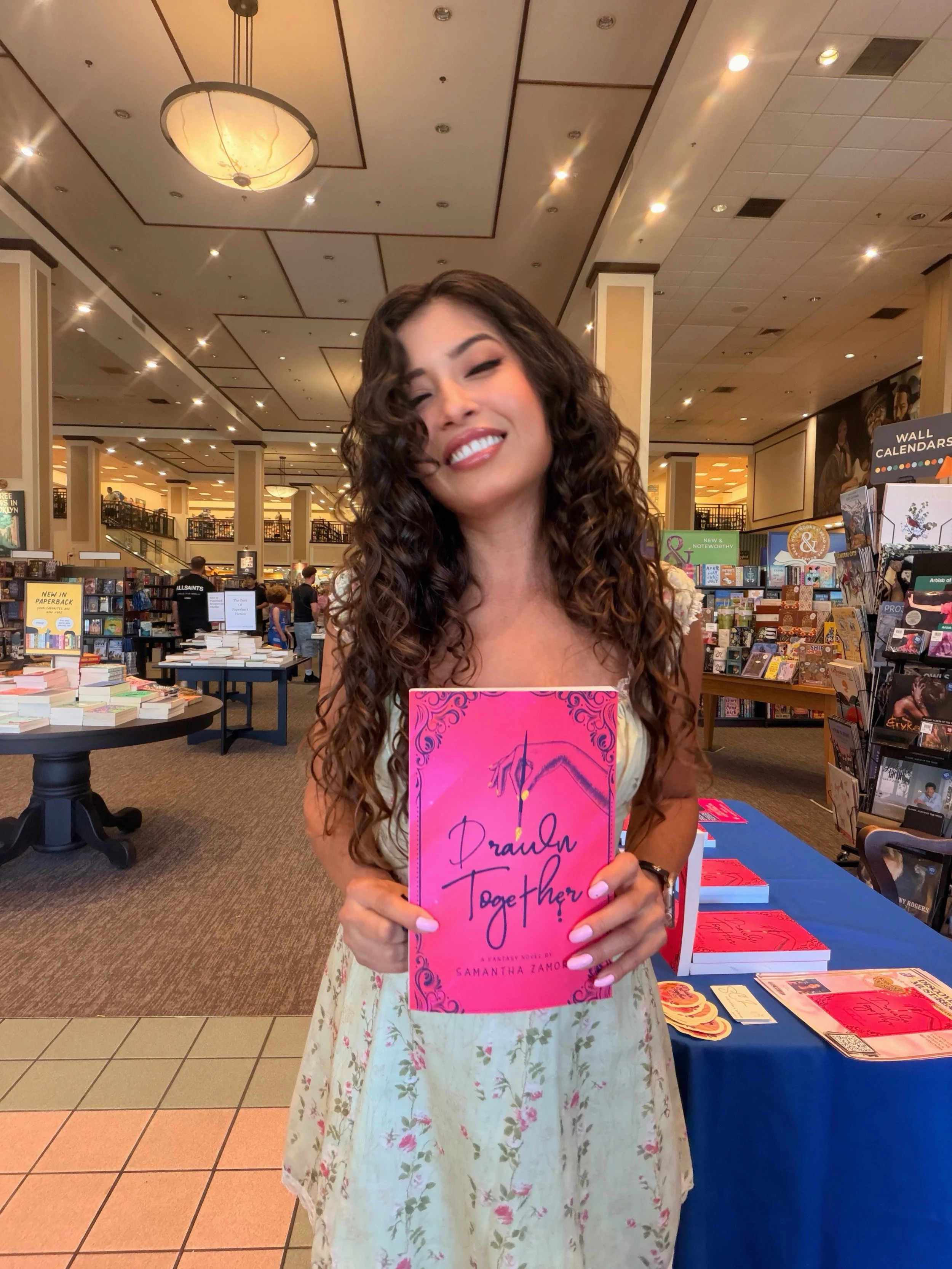 Author Samantha Zamora holding Drawn Together at her Barnes & Noble book signing at The Promenade at Westlake.