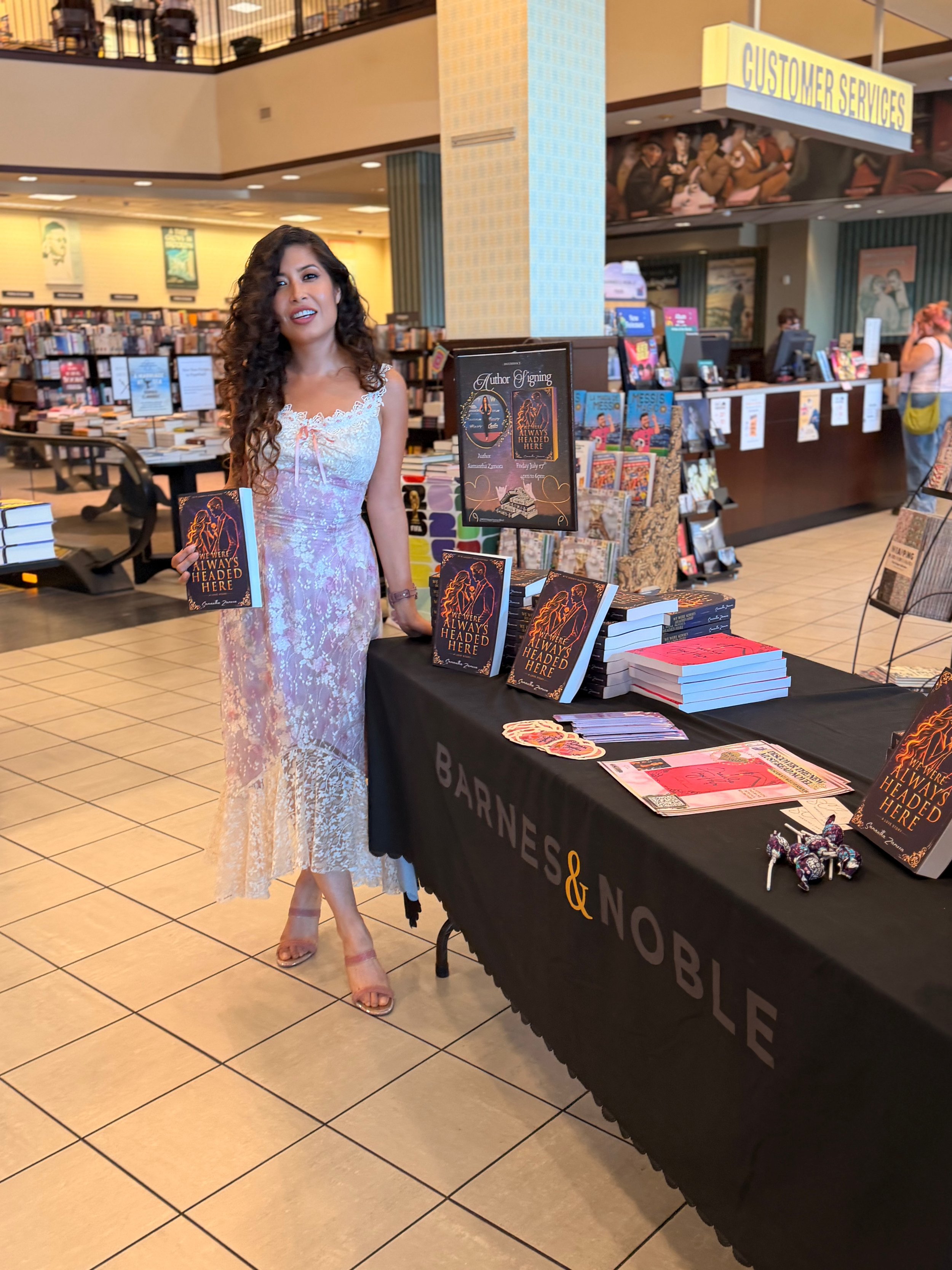 Samantha Zamora beside her author event display and books at Barnes & Noble in Torrance, California.