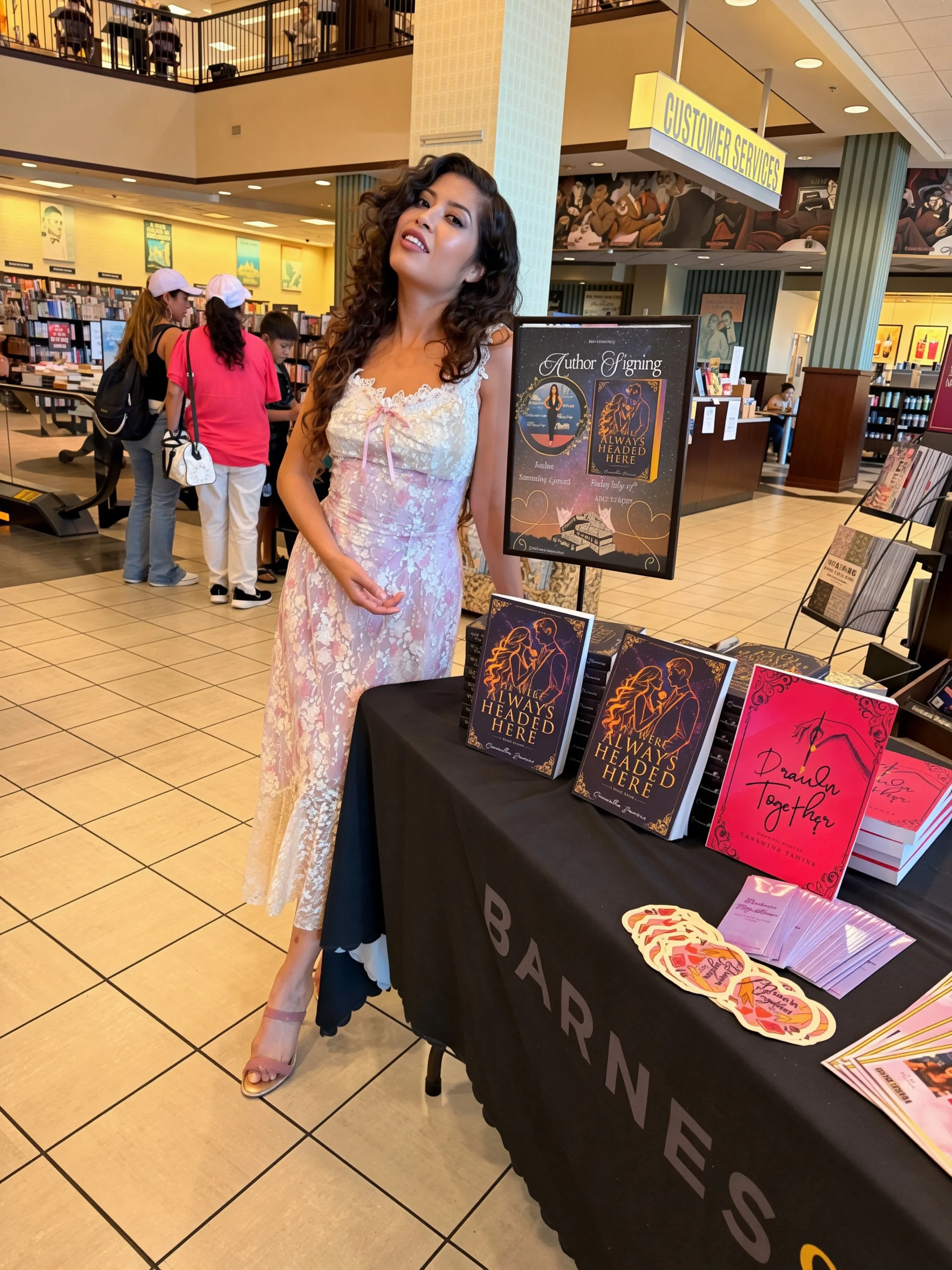 Author Samantha Zamora celebrating her Barnes & Noble Torrance book signing beside her event display.