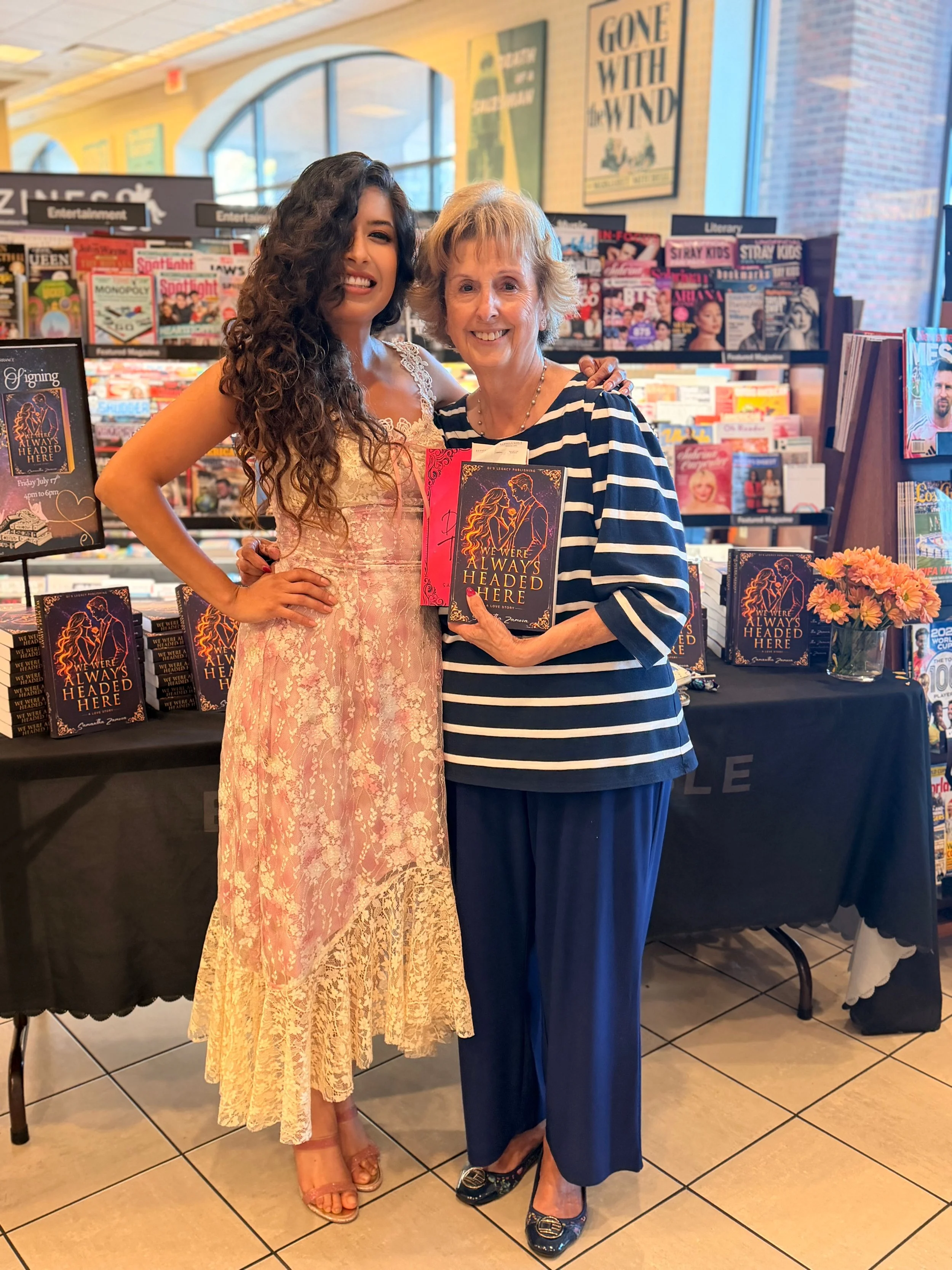 Samantha Zamora with a reader holding We Were Always Headed Here at Barnes & Noble in Torrance, California.