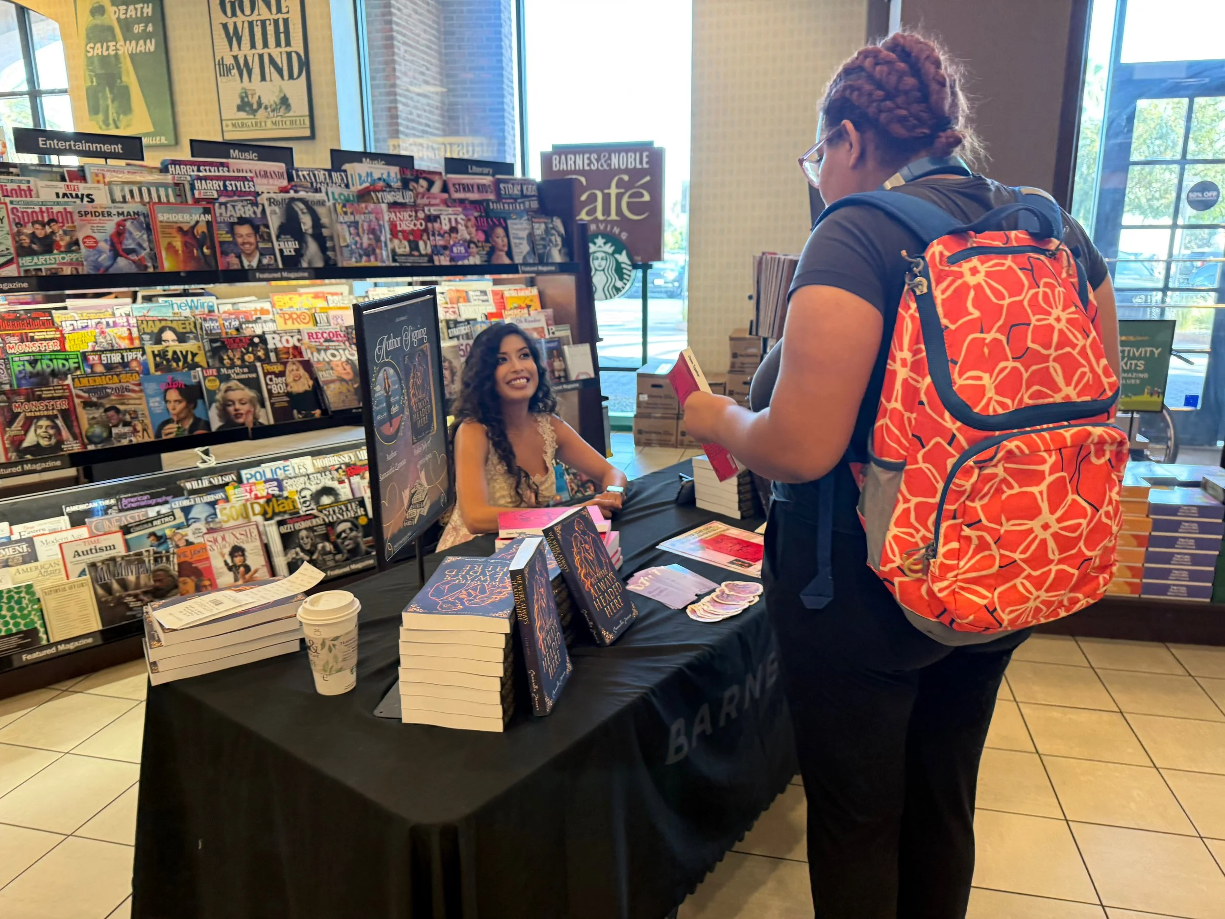Author Samantha Zamora signing books for a reader at her Barnes & Noble book signing in Torrance, California.