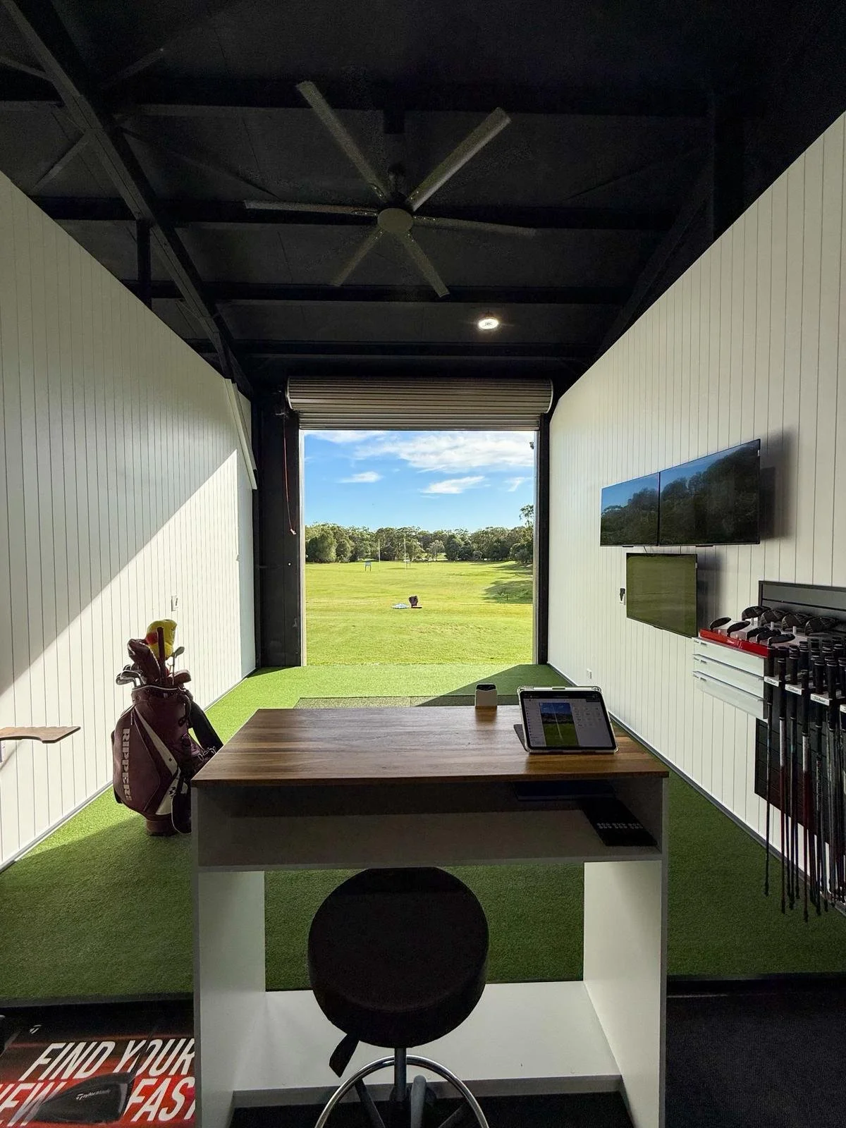 golf coaching bay looking down driving range