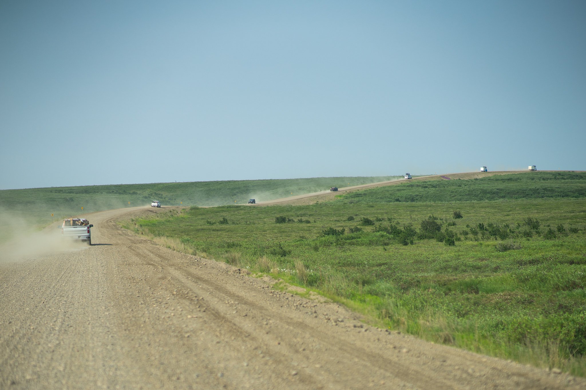 Convoy of vehicles full of riders and bicycles on our way from Inuvik to Tuktoyaktuk.jpg