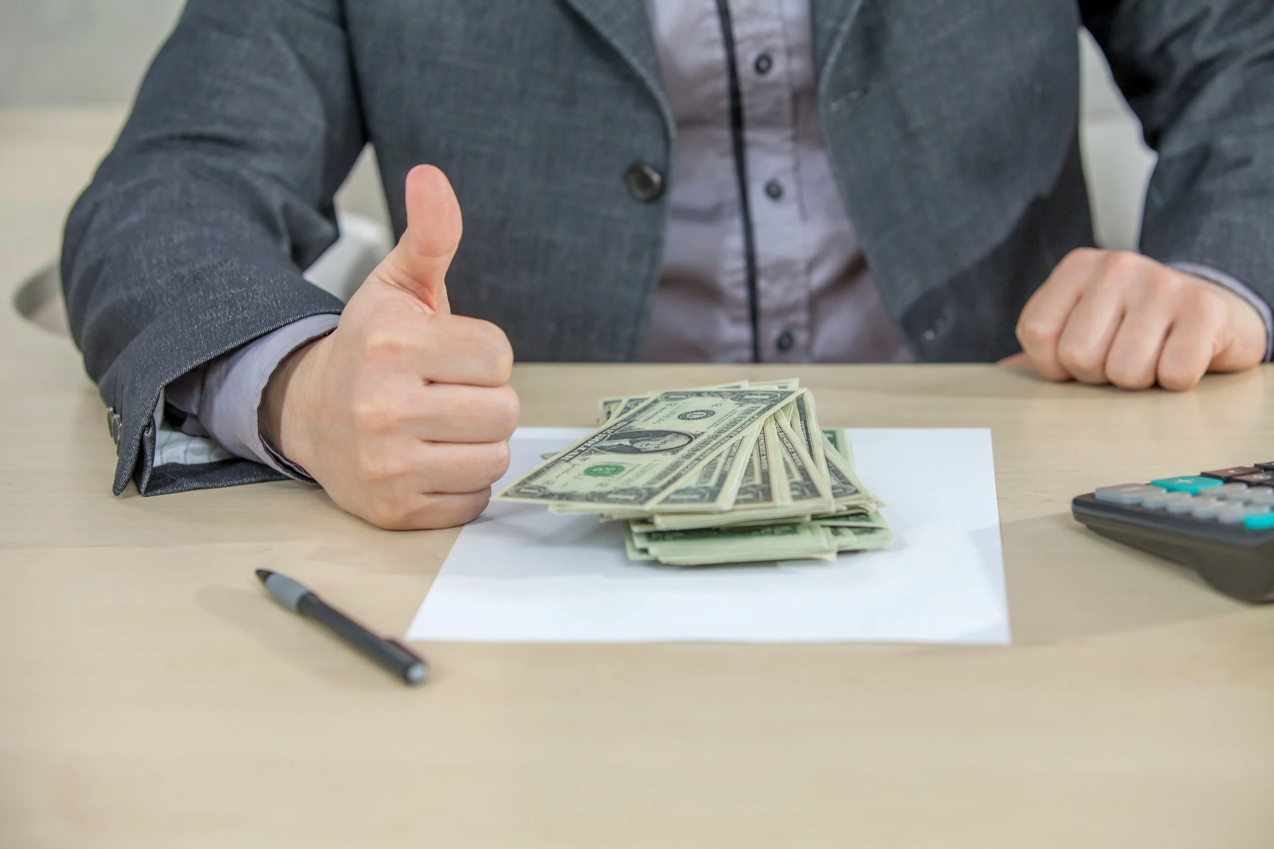 young-businessman-working-from-his-office-counting-cash-money.jpg