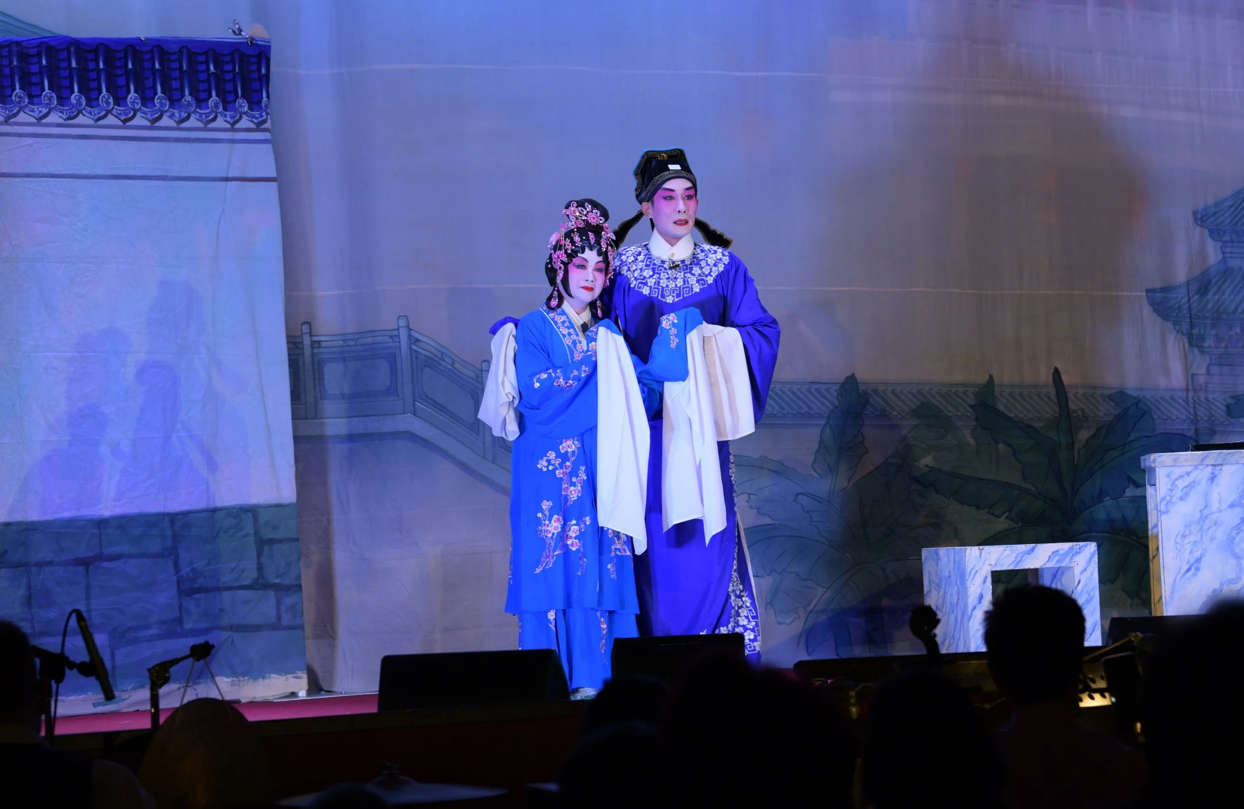 Two performers in blue costume singing their love to each other
