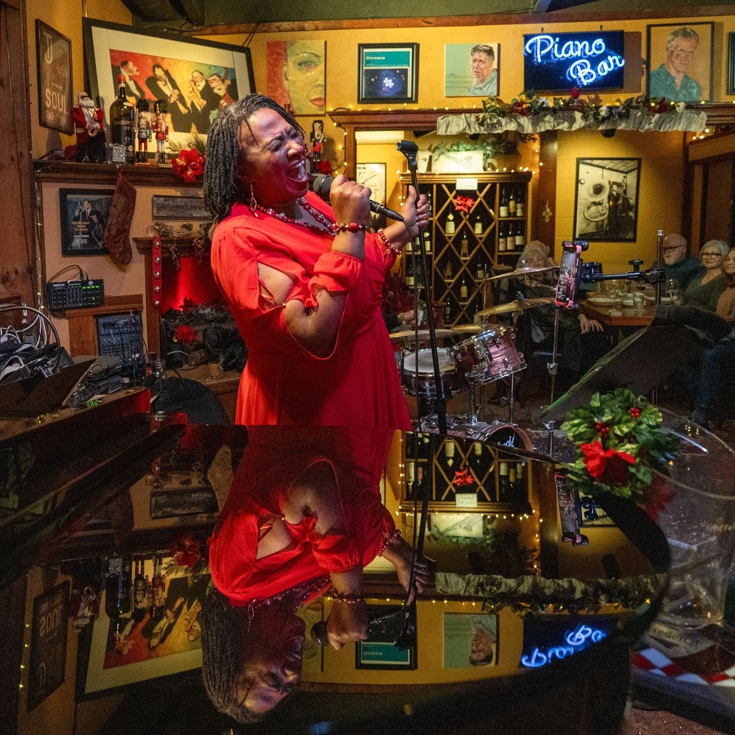 The irrepressible Ms. Vee singing jazz standards and a little blues with Ron Steen's Band at Arrivederci Wine &amp; Jazz. Vee, as always, gave her all, which is a lot by every standard. The reflection of Vee in the piano was irresistible lens candy. 